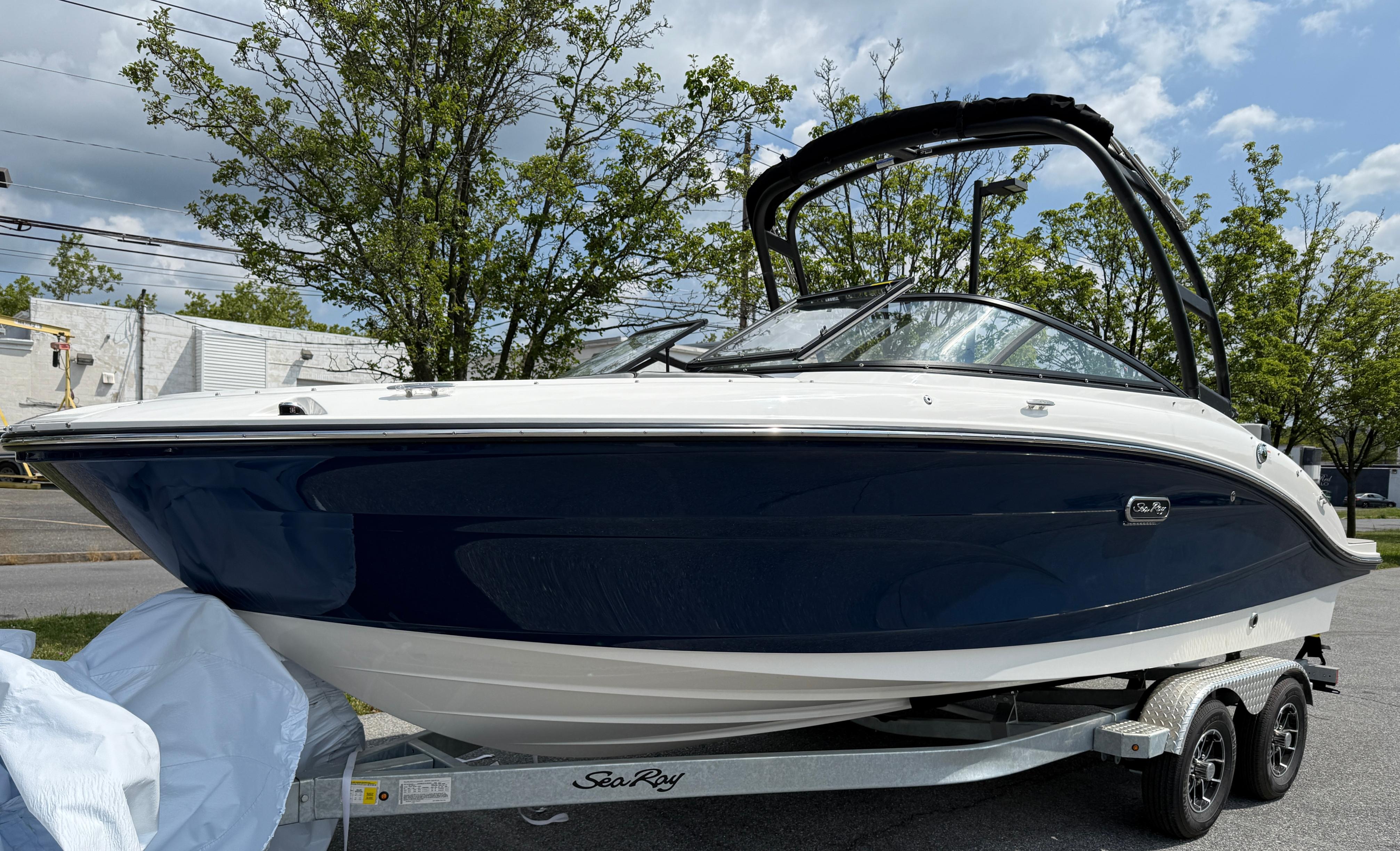2026 Sea Ray SPX 210 Outboard boat on trailer, parked outdoors.