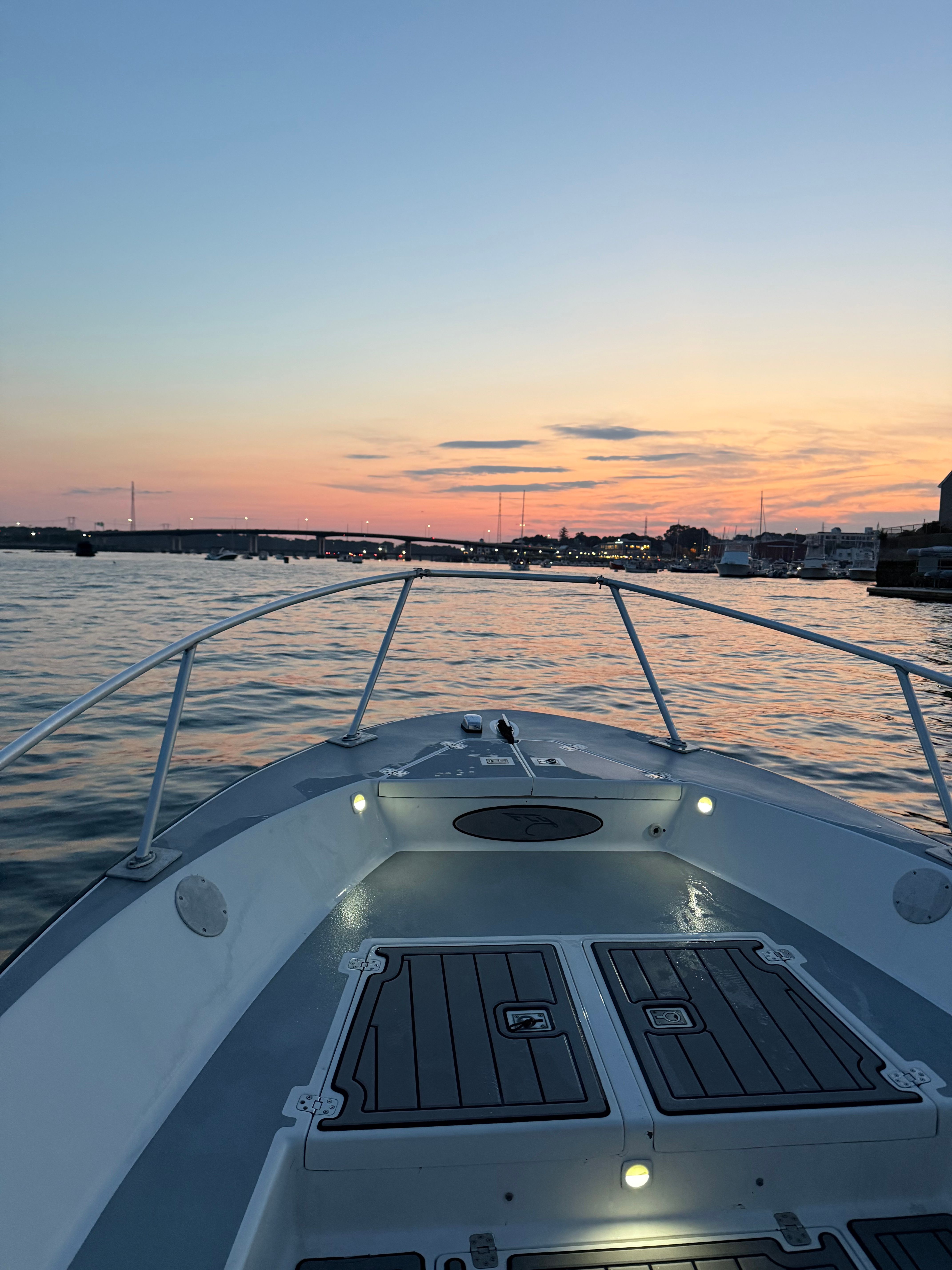 Custom Sea Fly 2004 boat at sunset on calm waters.