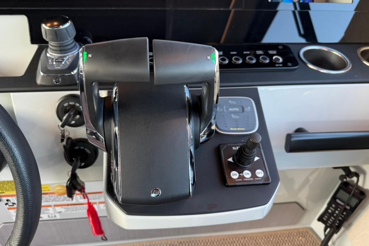 Control panel of 2024 Saxdor 320 GTC boat with throttle and joystick controls.