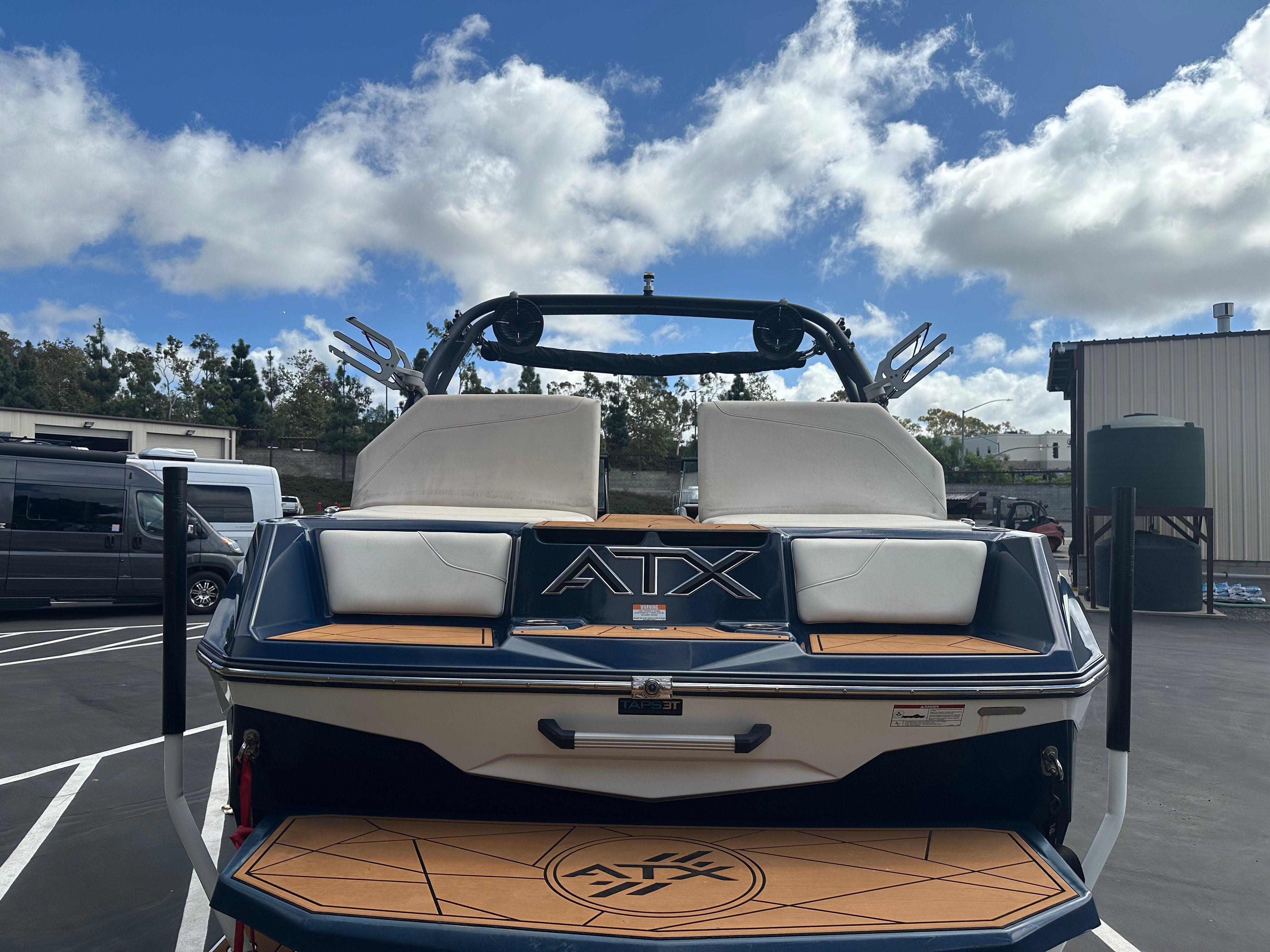 2021 ATX Surf Boats 22 Type-S on parking lot under sunny skies.