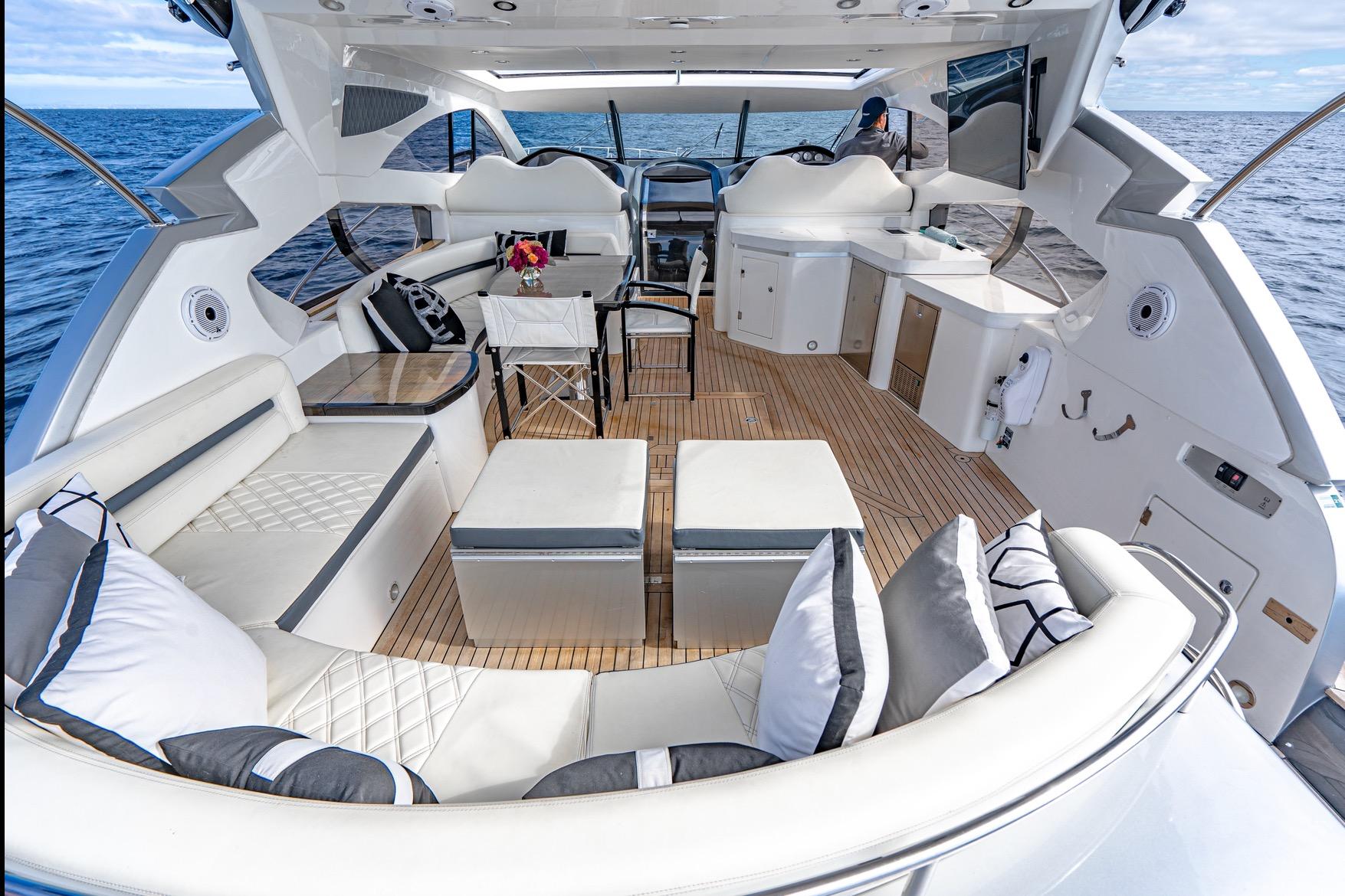 Luxurious 2021 Sunseeker Predator 68 yacht interior with elegant seating and ocean view.
