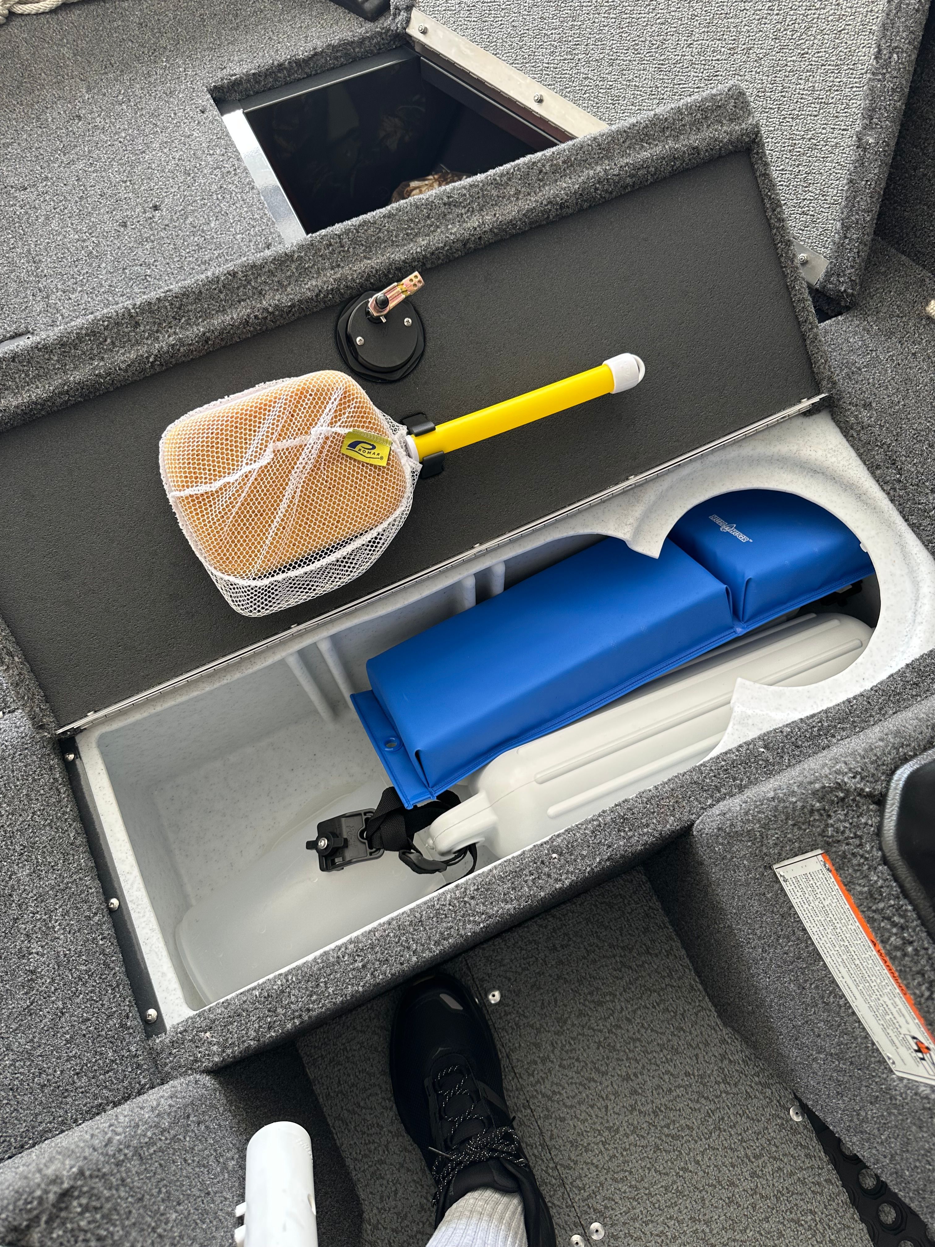 The image shows a storage compartment inside a 2025 Lund Pro Angler 1650 boat.