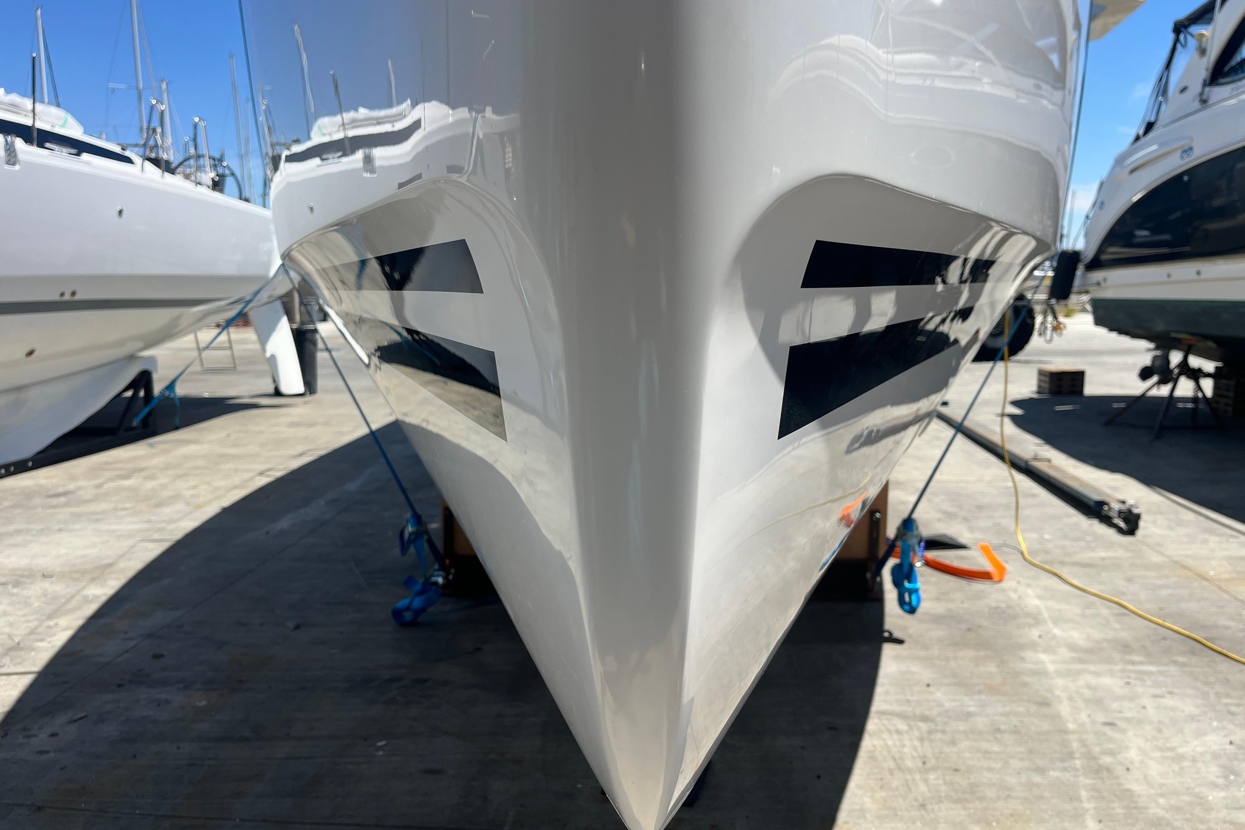 2025 Hanse 360 yacht bow view in a marina, showcasing sleek design and modern features.