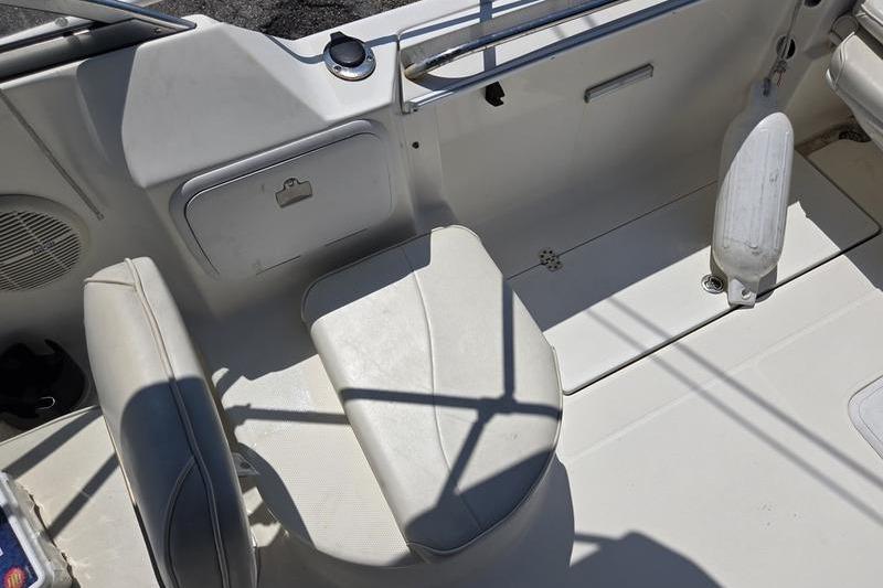 2004 Aquasport 215 Osprey Sport boat interior with seating and storage compartments.