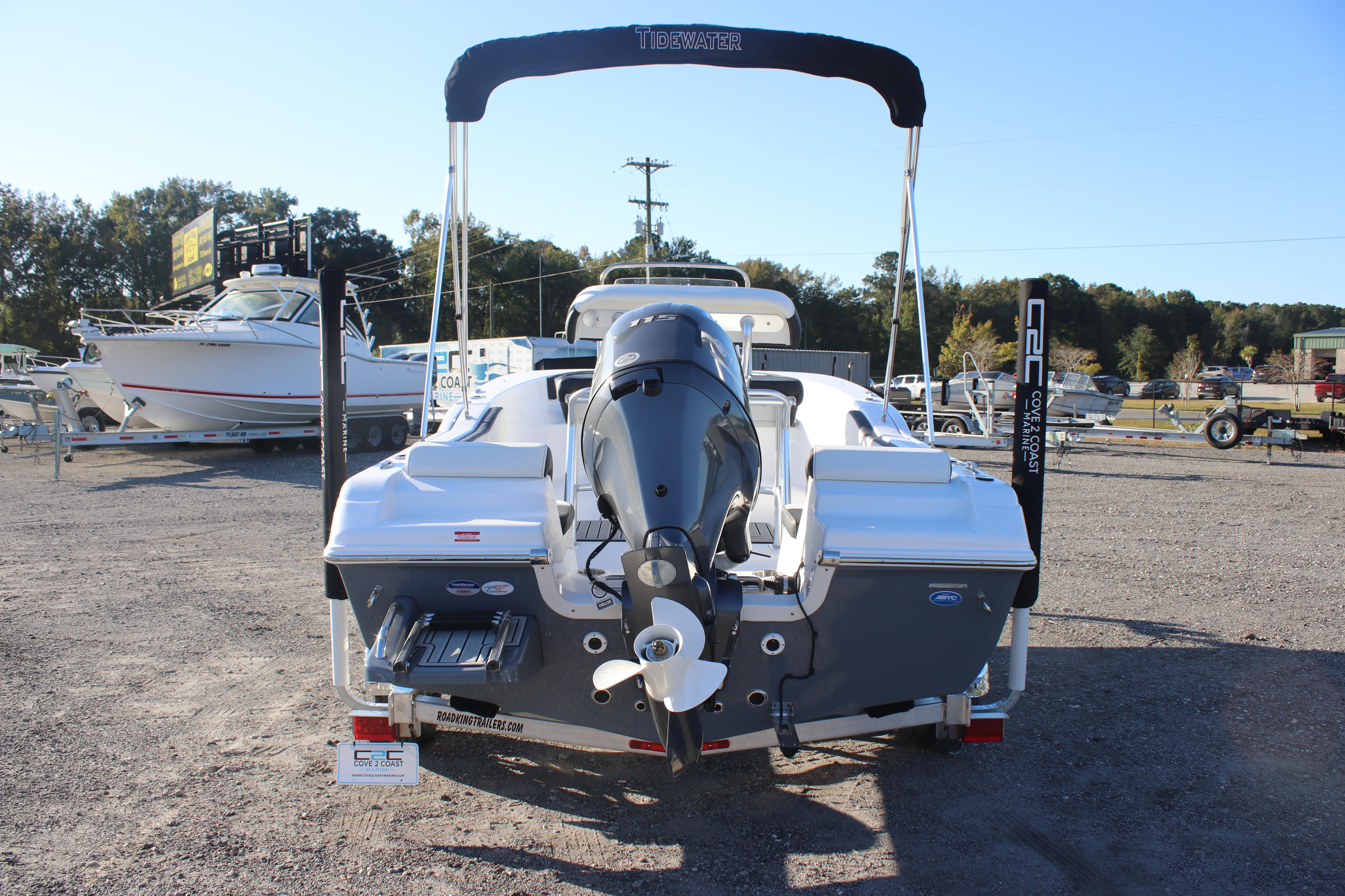 2026 Tidewater 180 CC Adventure boat, rear view, parked on gravel lot.