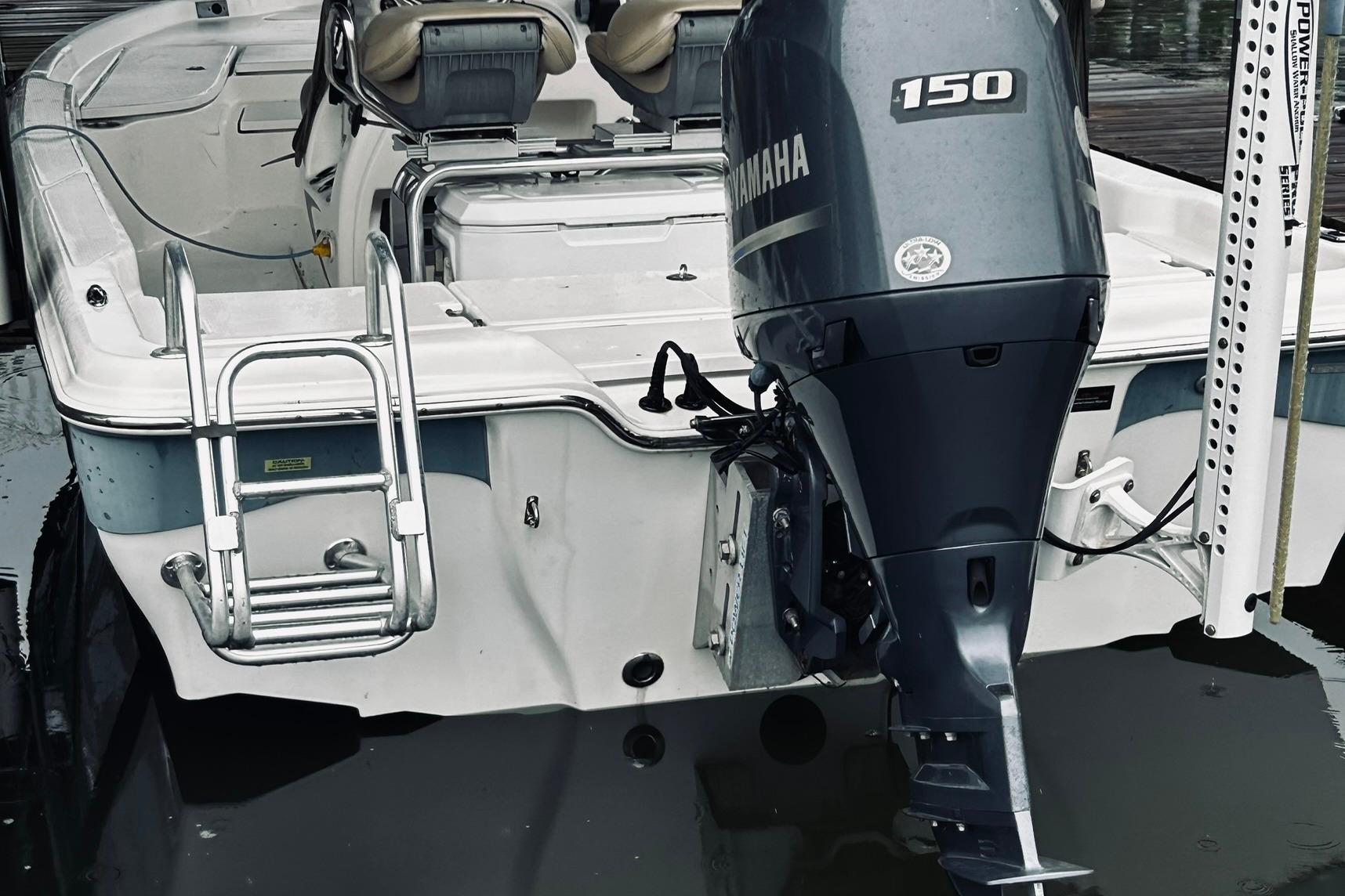 2017 Blue Wave 2200 PureBay boat with Yamaha 150 engine, docked with ladder visible.