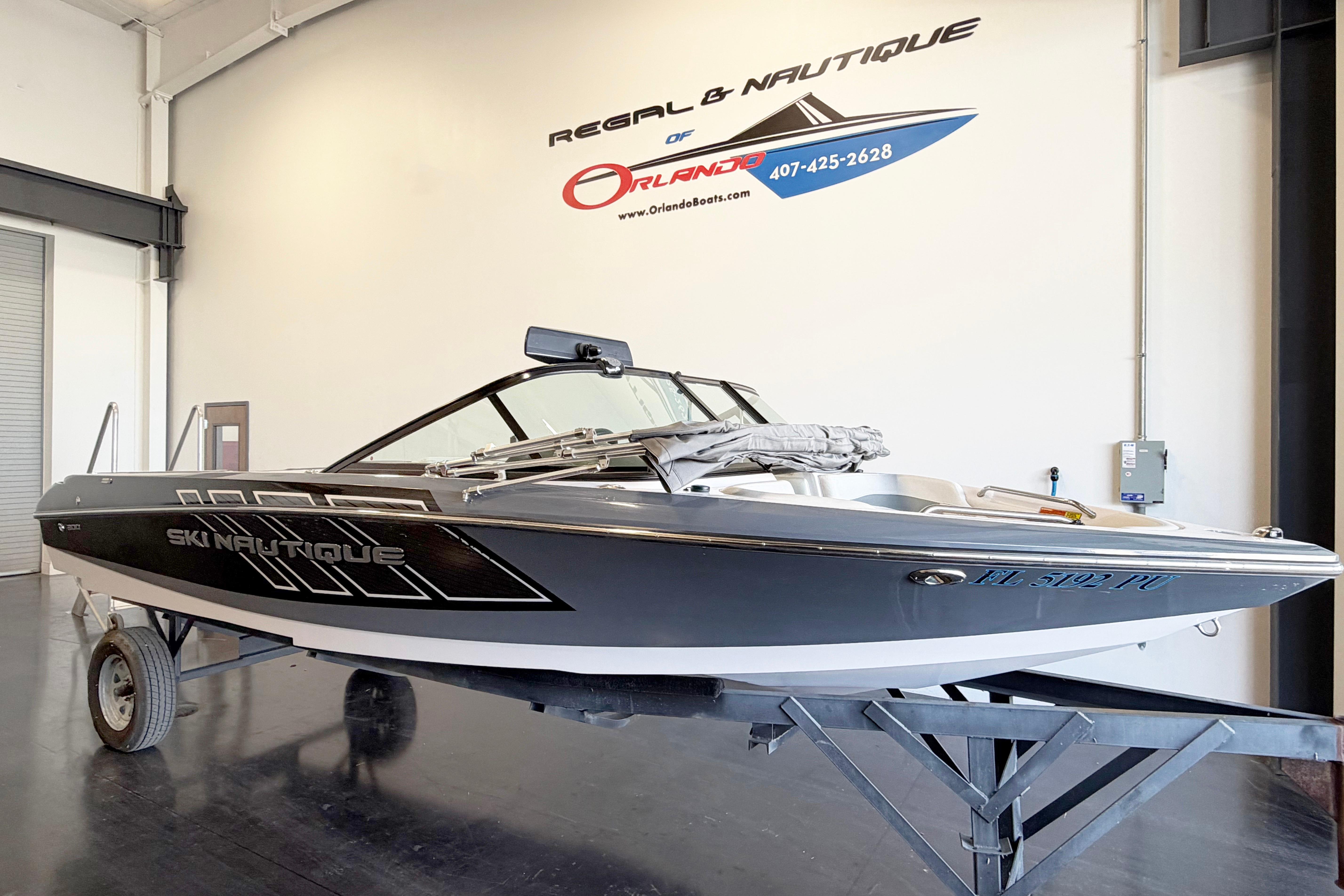 2014 Nautique Ski Nautique 200 Open Bow boat displayed indoors on a trailer.