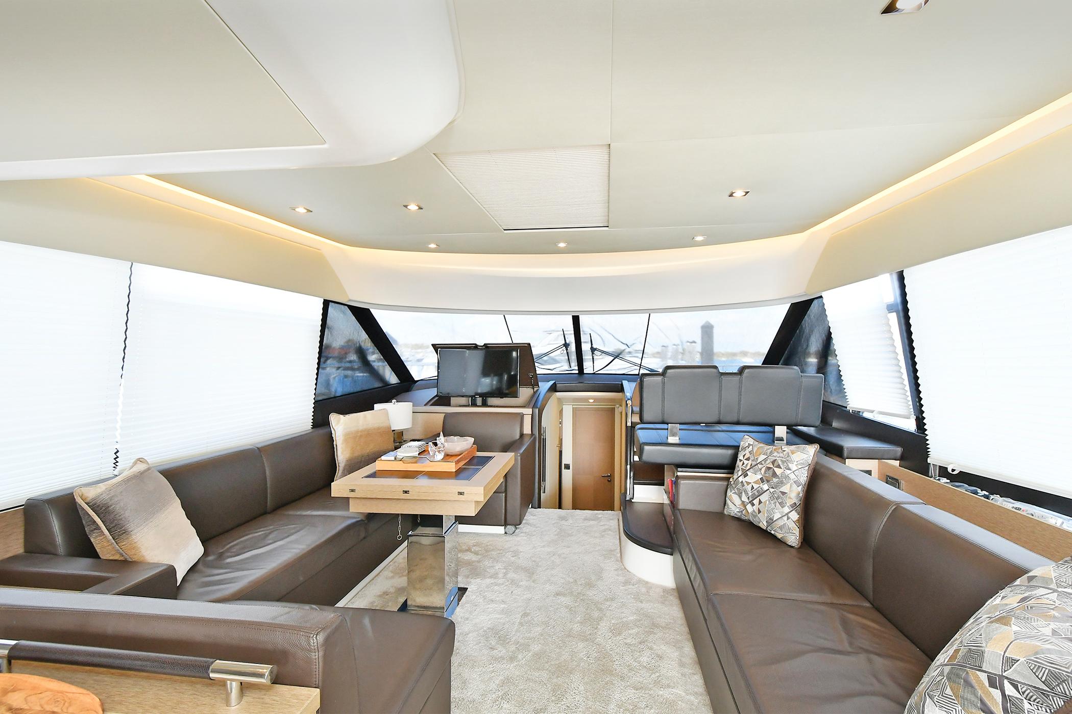 Luxurious interior of 2018 Prestige 560 Fly yacht with elegant seating and modern design.