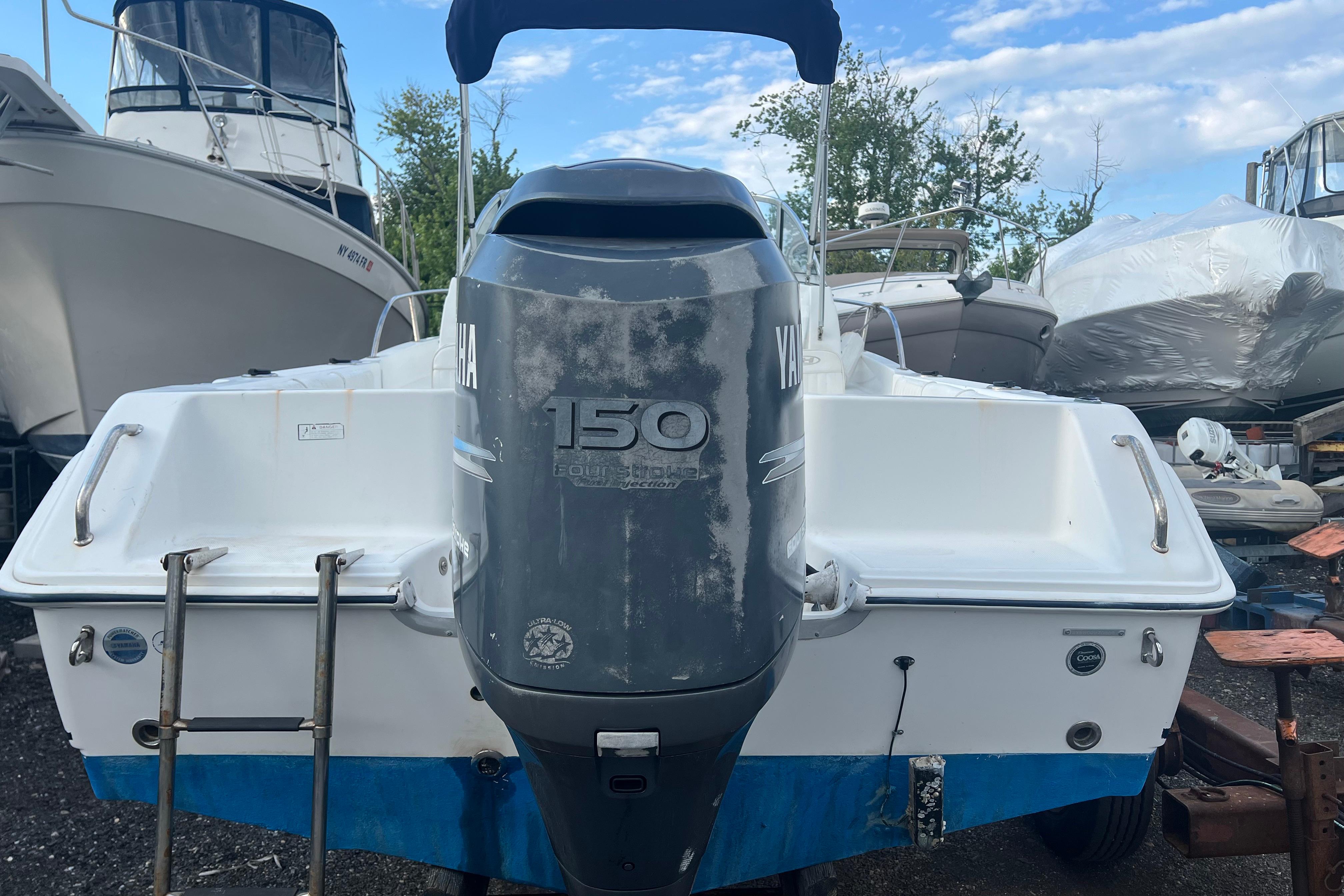 2008 Sea Hunt Victory 207 boat with Yamaha 150 engine, docked outdoors.
