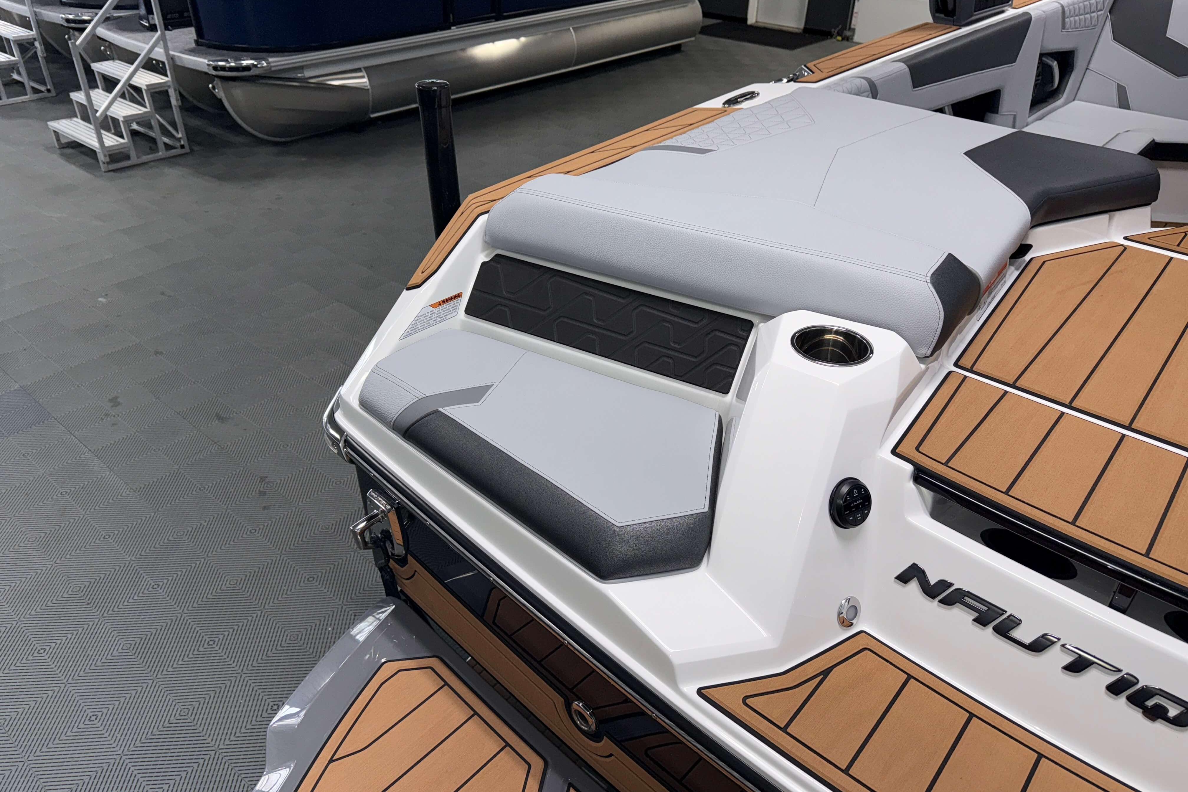 2026 Nautique Super Air Nautique GS22 boat interior with sleek seating and teak flooring.
