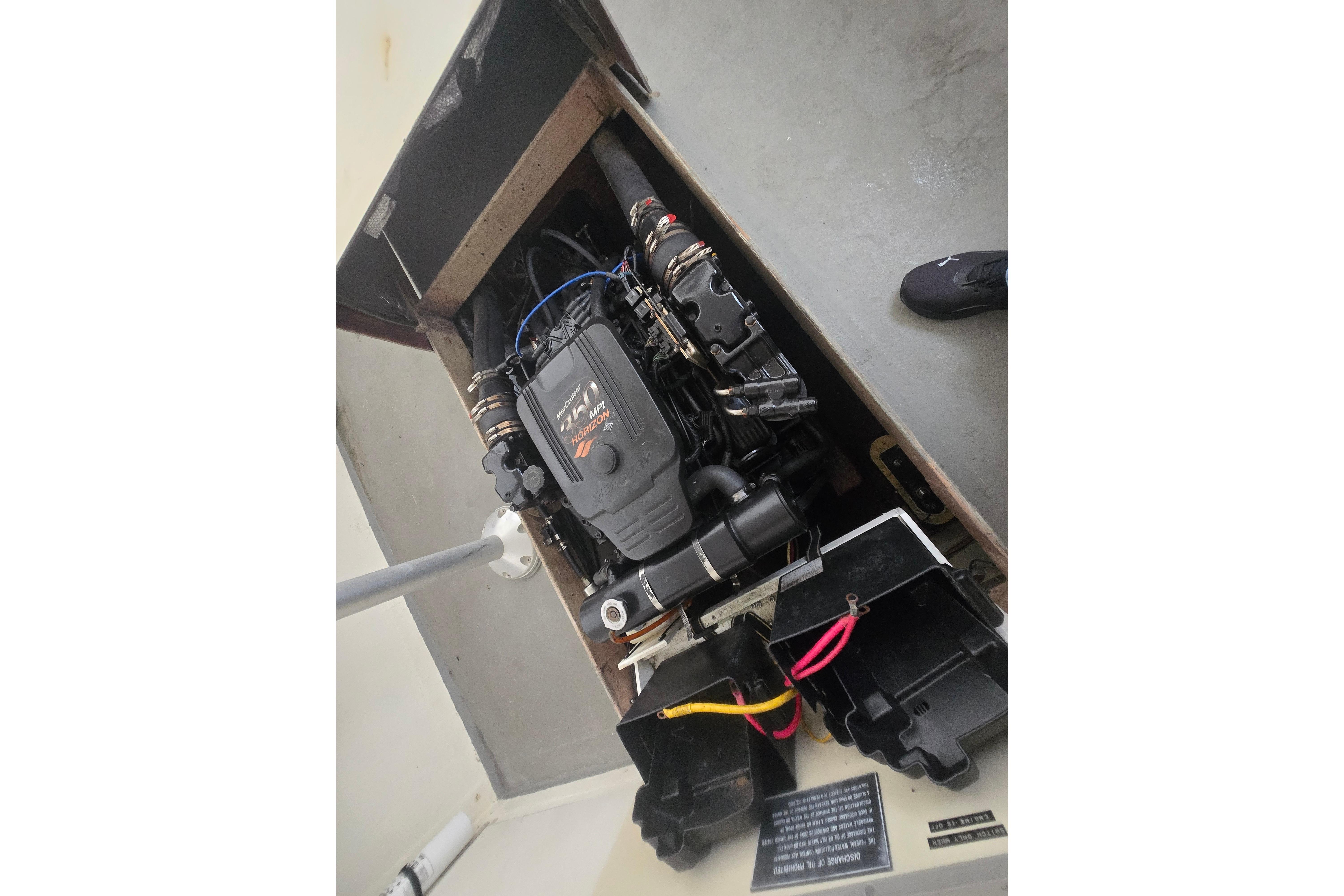 Engine compartment of a 1982 SISU 26 boat, showcasing the motor and components.
