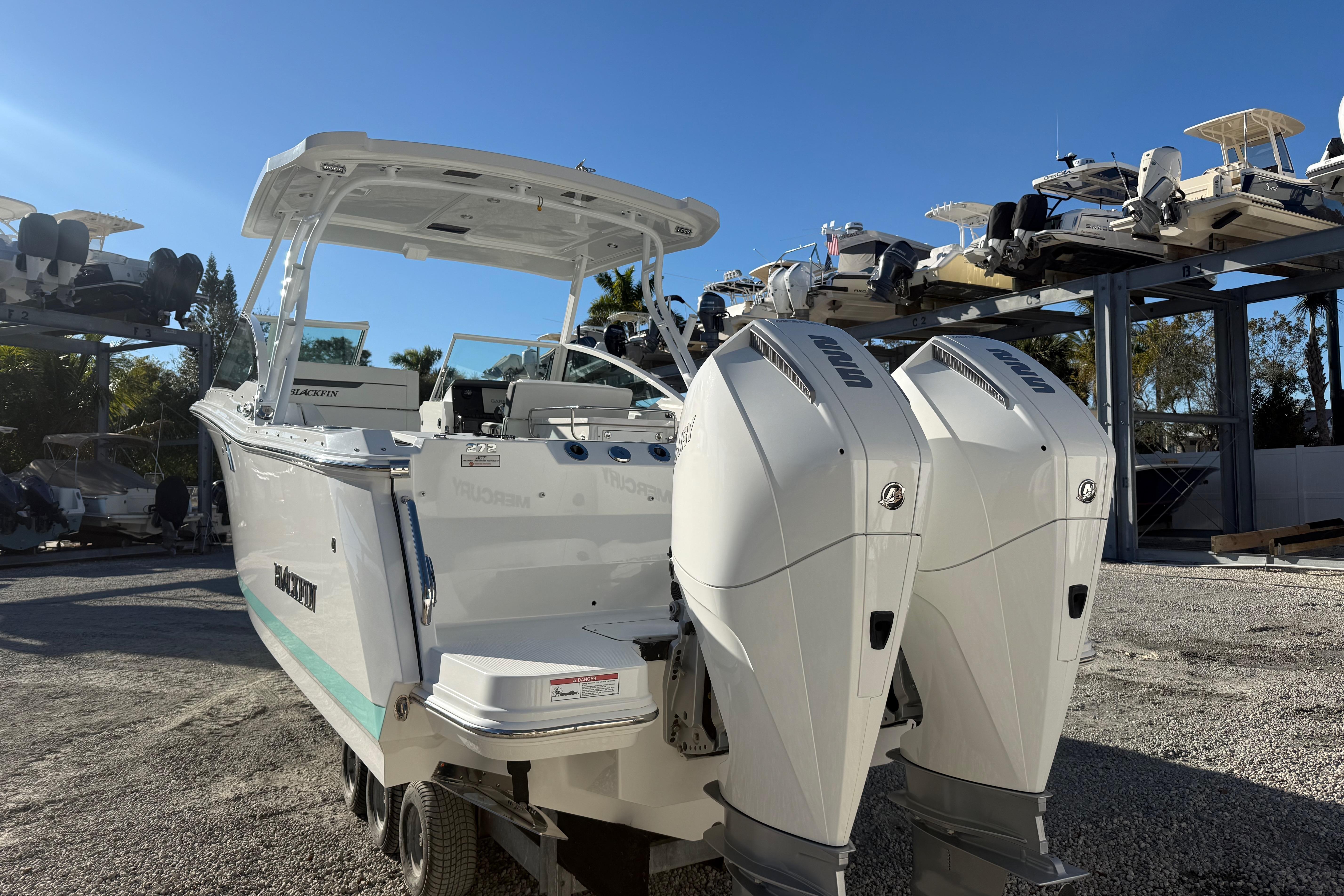 2022 Blackfin 272 DC boat with dual outboard engines in a marina setting.