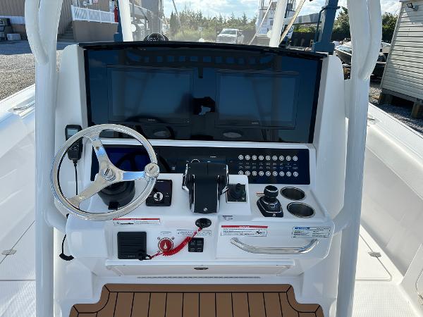2025 Southport 33 FE boat dashboard with steering wheel and control panel.