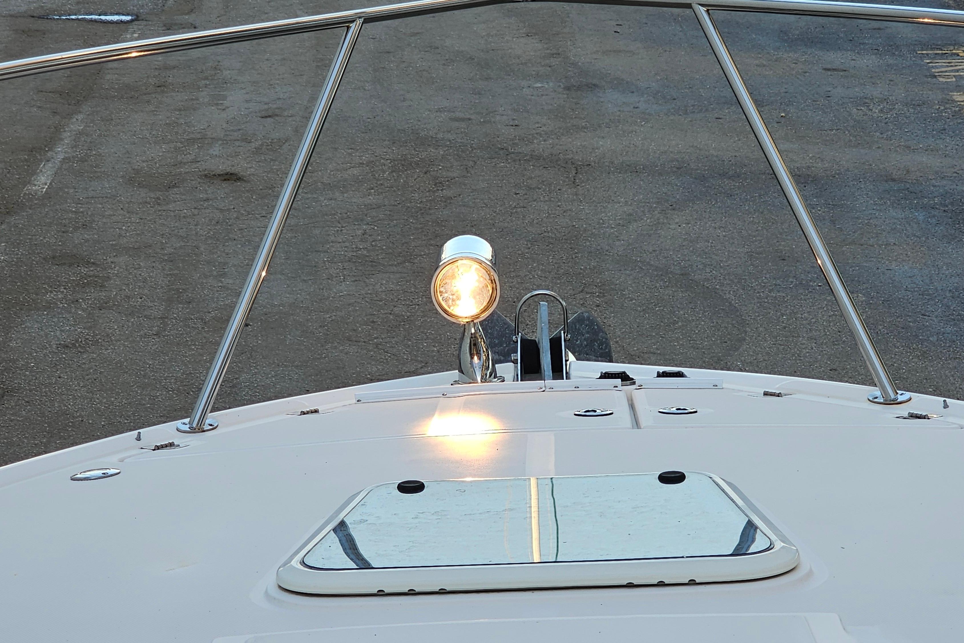 Bow view of 2005 Regal 3060 Window Express with spotlight and railing.