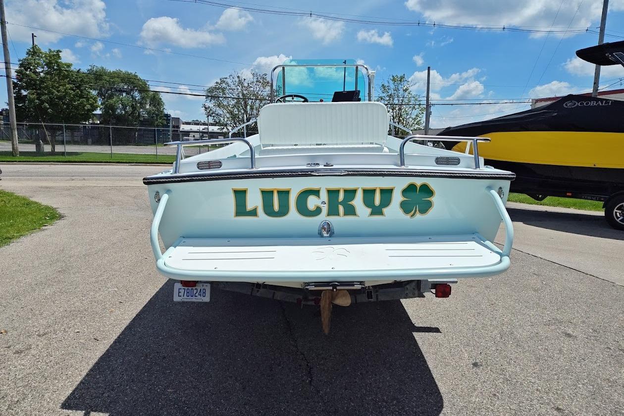 1975 Shamrock 200 Open boat named "Lucky" with shamrock design, parked outdoors.
