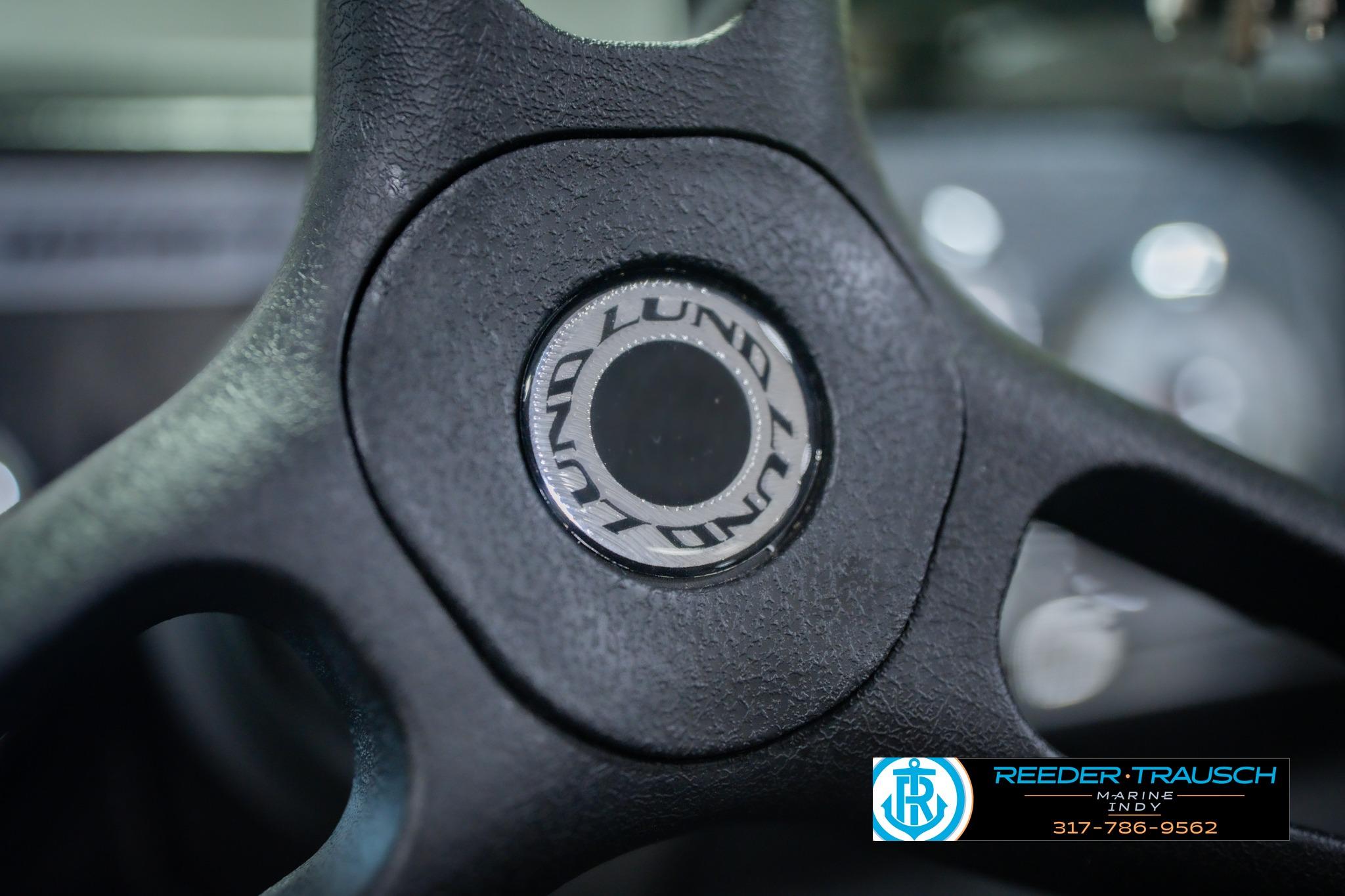Close-up of 2026 Lund 1775 Impact XS steering wheel with logo.