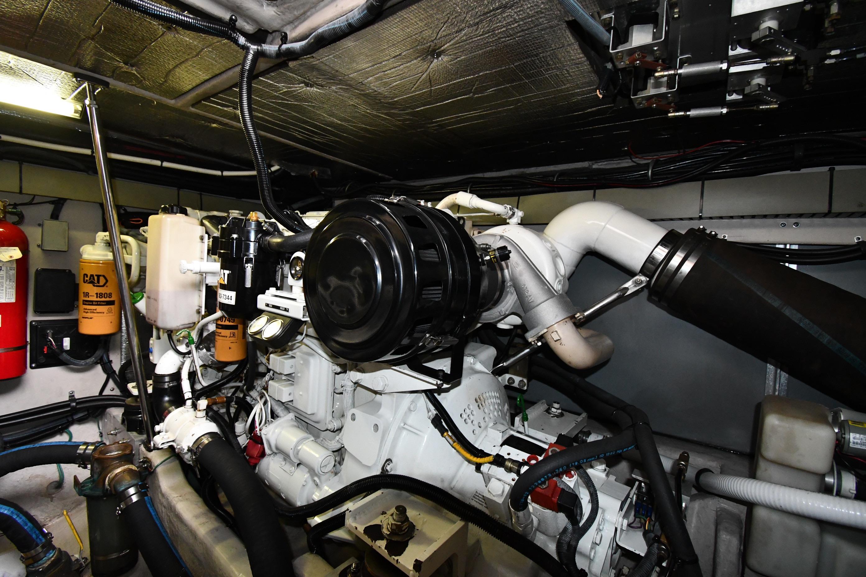 Engine room of 2001 Sea Ray 540 Sundancer with visible CAT components and fire extinguisher.