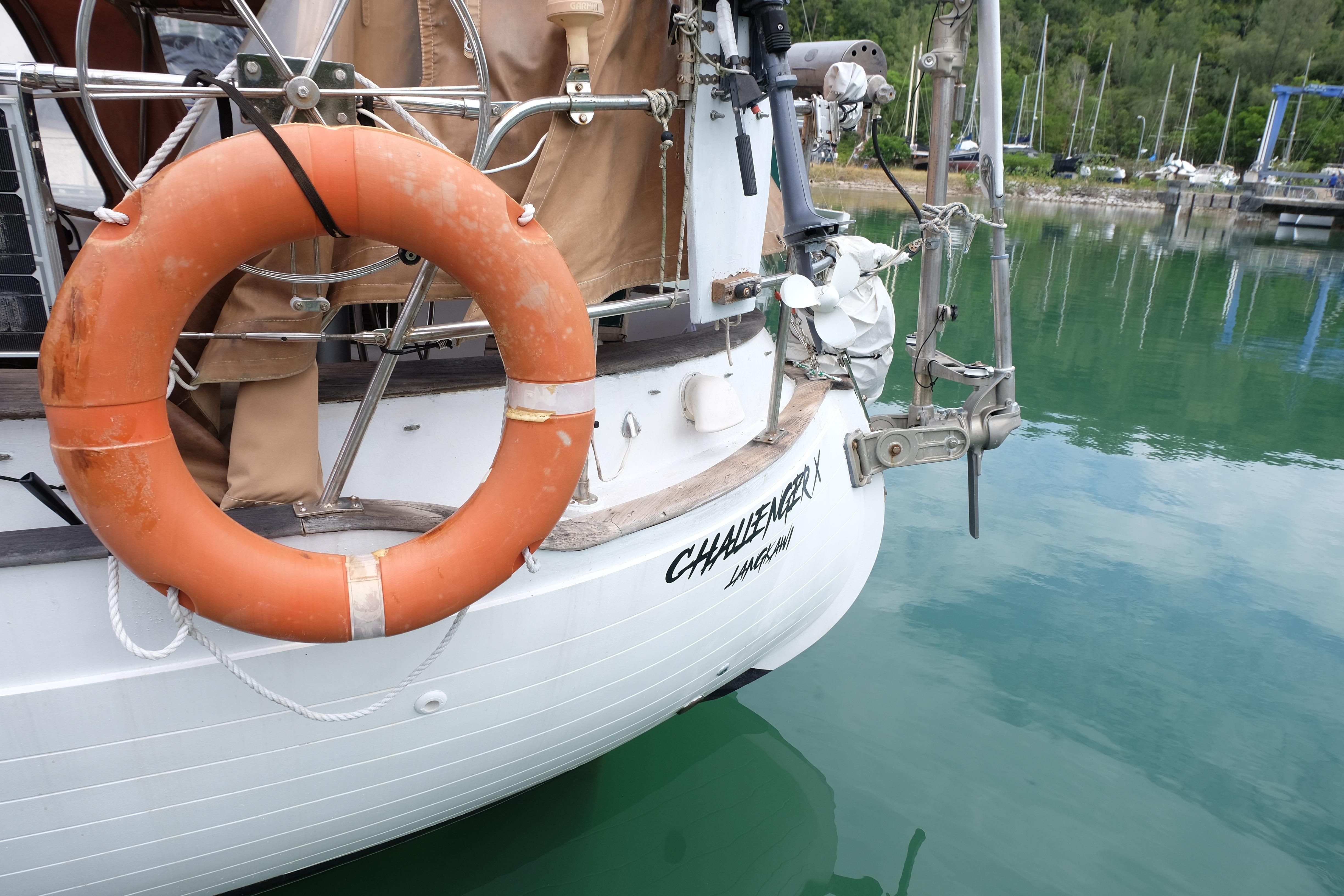 1979 Westwind 35 sailboat with lifebuoy, docked in calm waters.