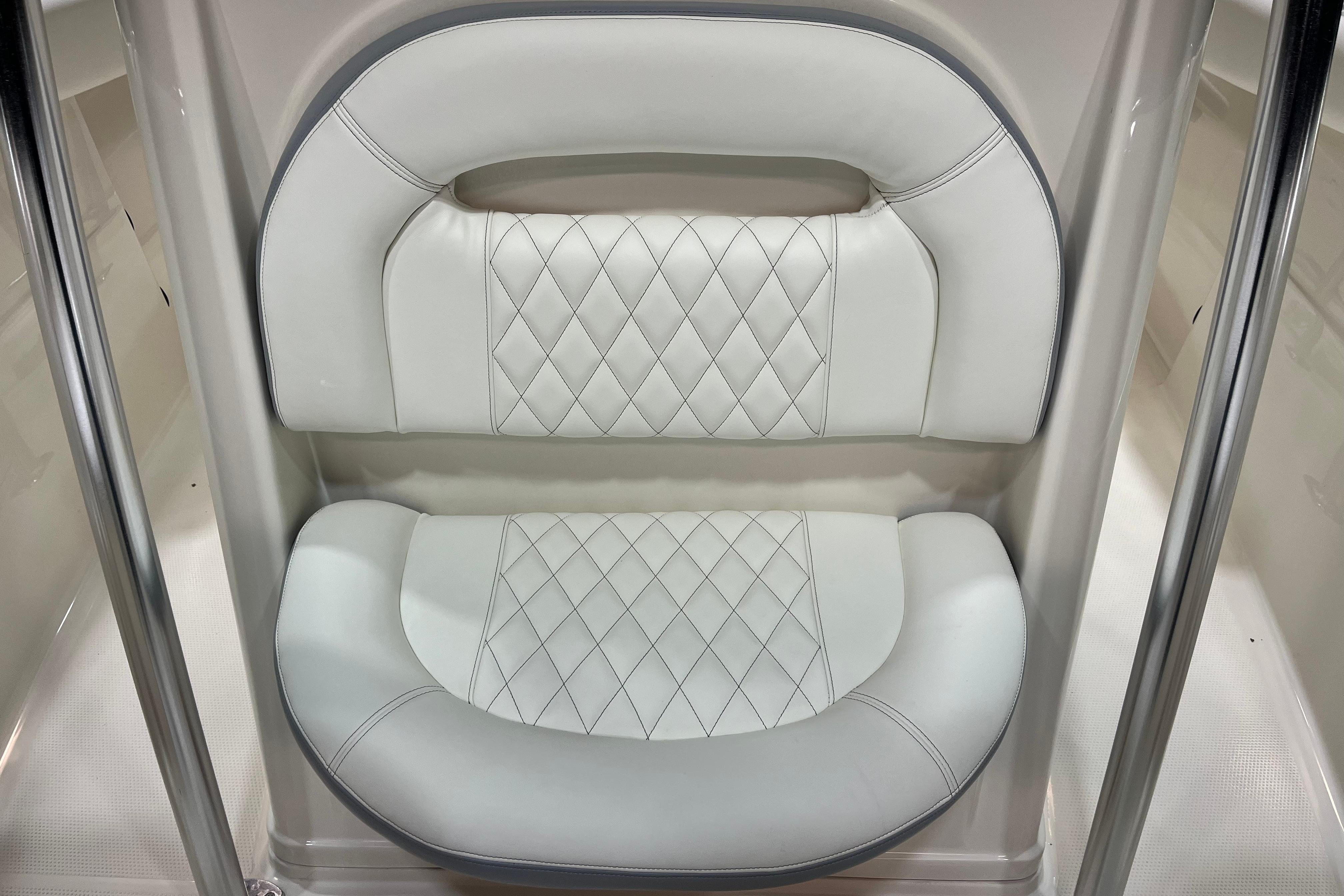 2022 Sailfish 242 CC boat seat with diamond-stitched white upholstery.