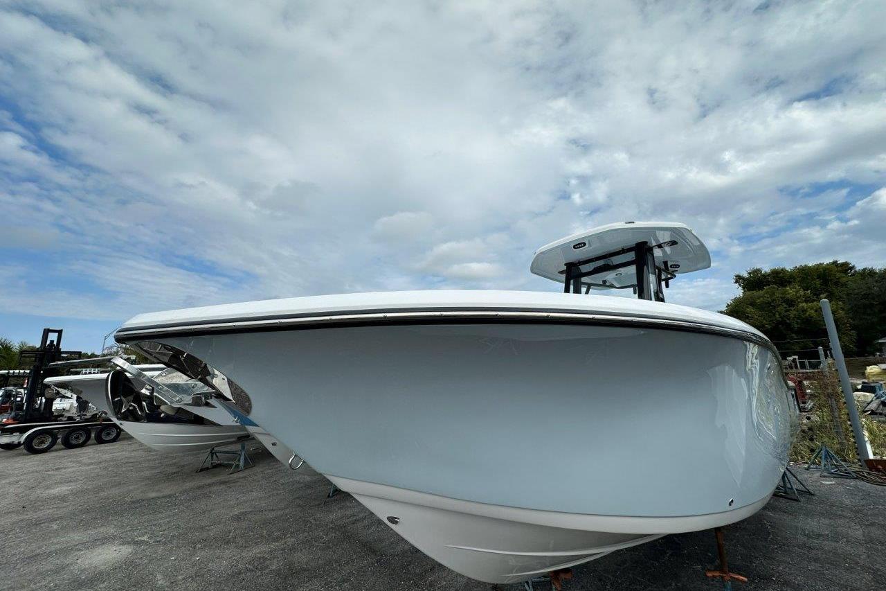 2026 Tidewater 272 LXF boat with sleek design under cloudy sky.