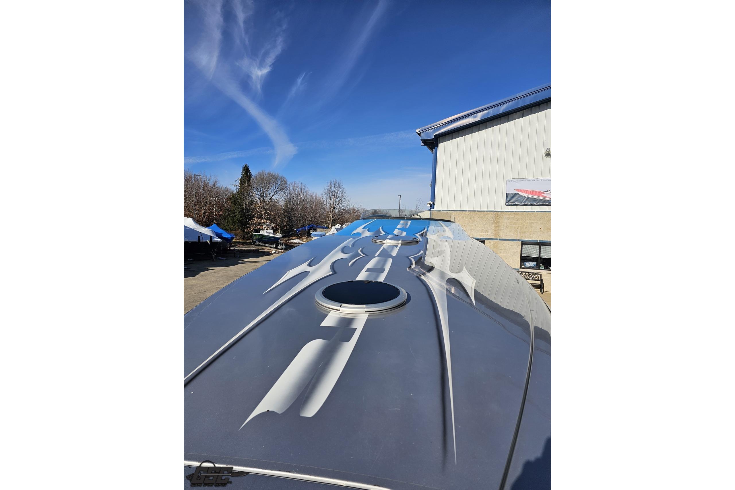 2007 Hustler 41 Razor boat with sleek design and custom graphics under clear blue sky.