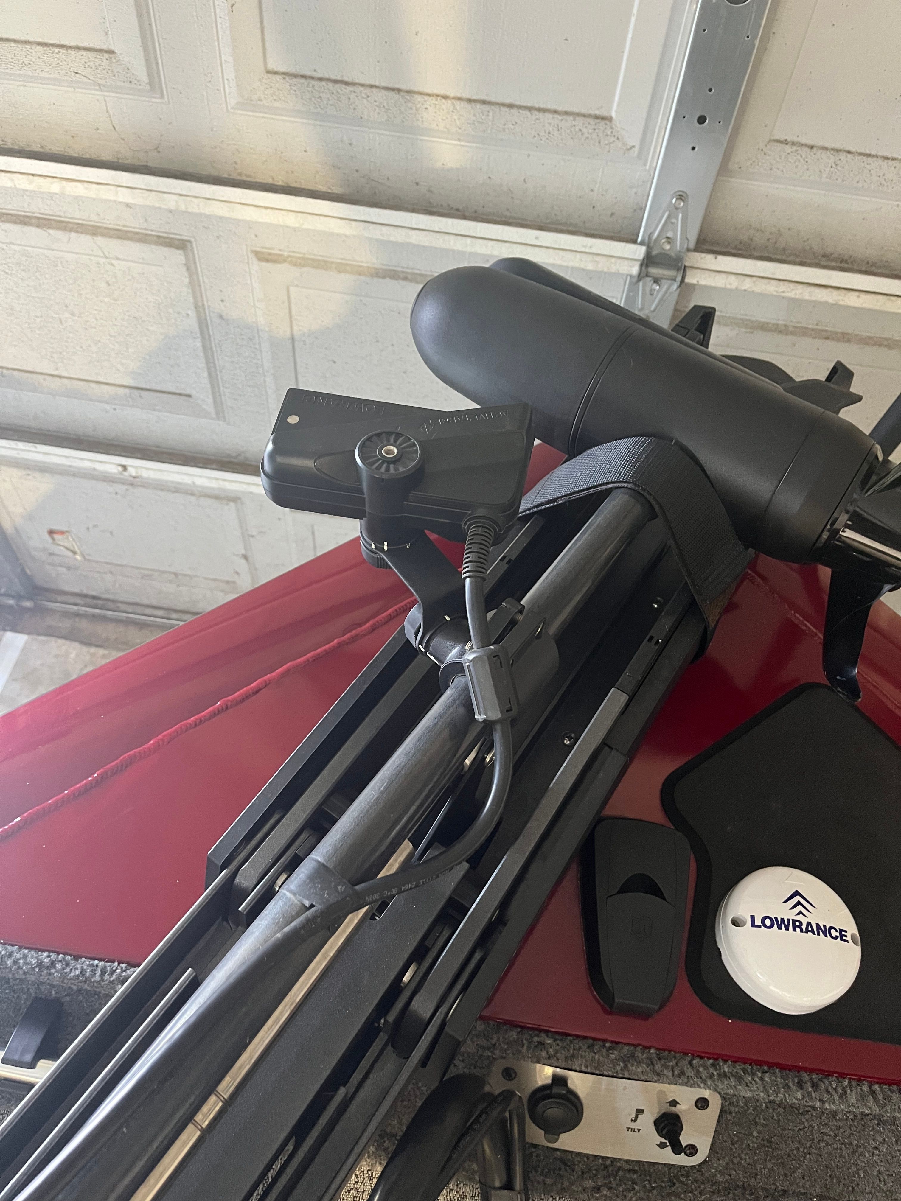 Close-up of a boat steering system with Lowrance technology in a garage.