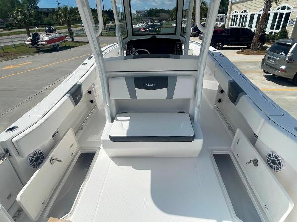 2023 Robalo R270 boat interior with open storage compartments and seating.