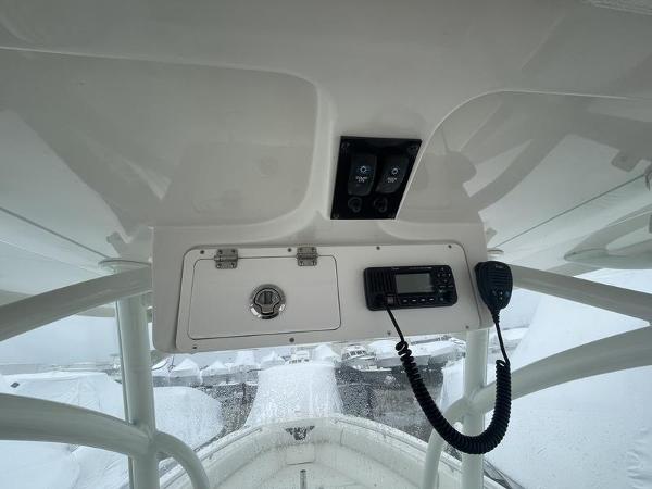 2023 Sailfish 290 CC boat console with radio and storage compartment.