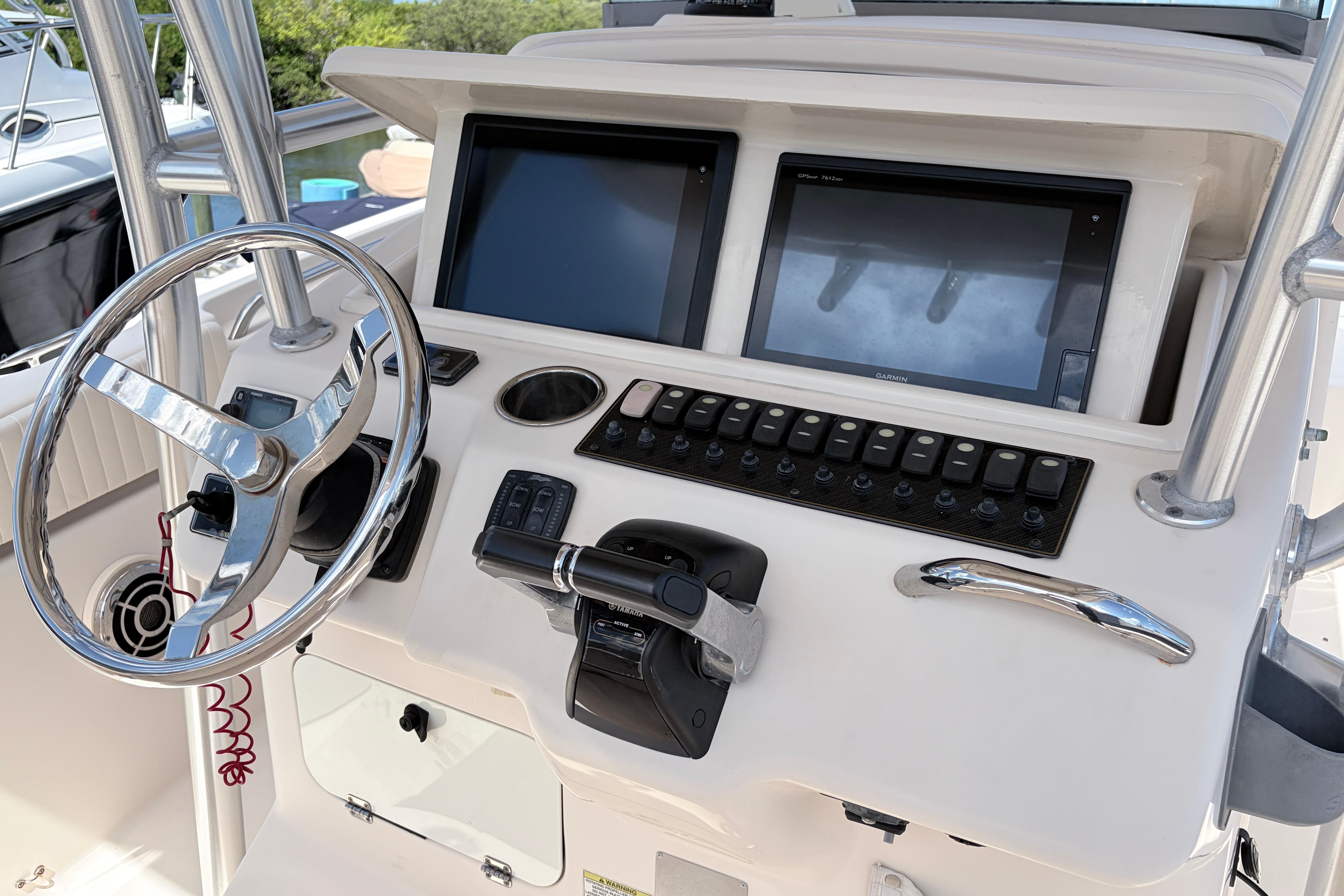 Helm of 2014 Grady-White Canyon 283 boat with dual screens and controls.