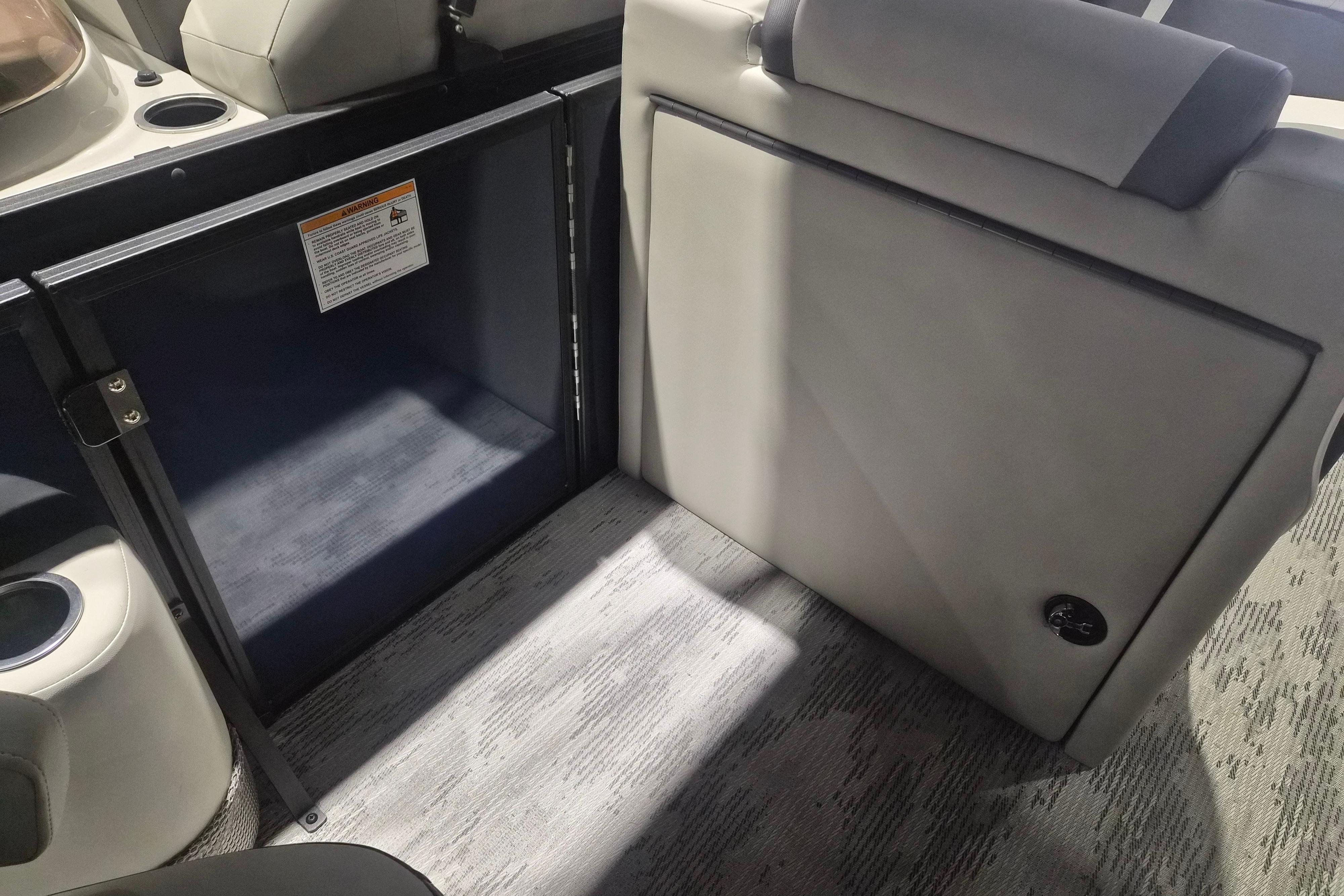 Interior of 2026 Sylvan R-22 LZ DH boat, featuring seating and storage area.