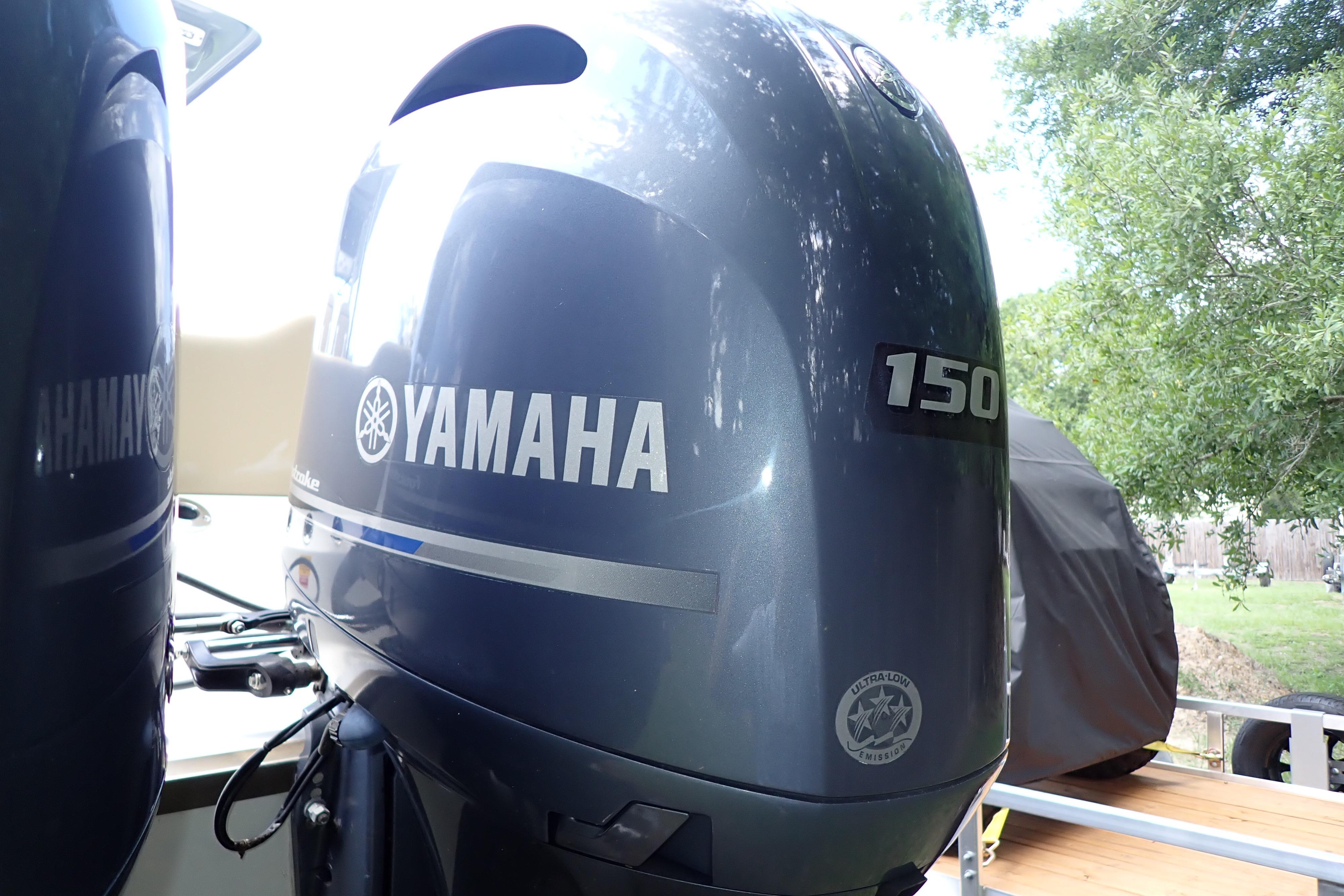 Yamaha 150 outboard motor on 2019 Key West 263 FS boat, outdoors.