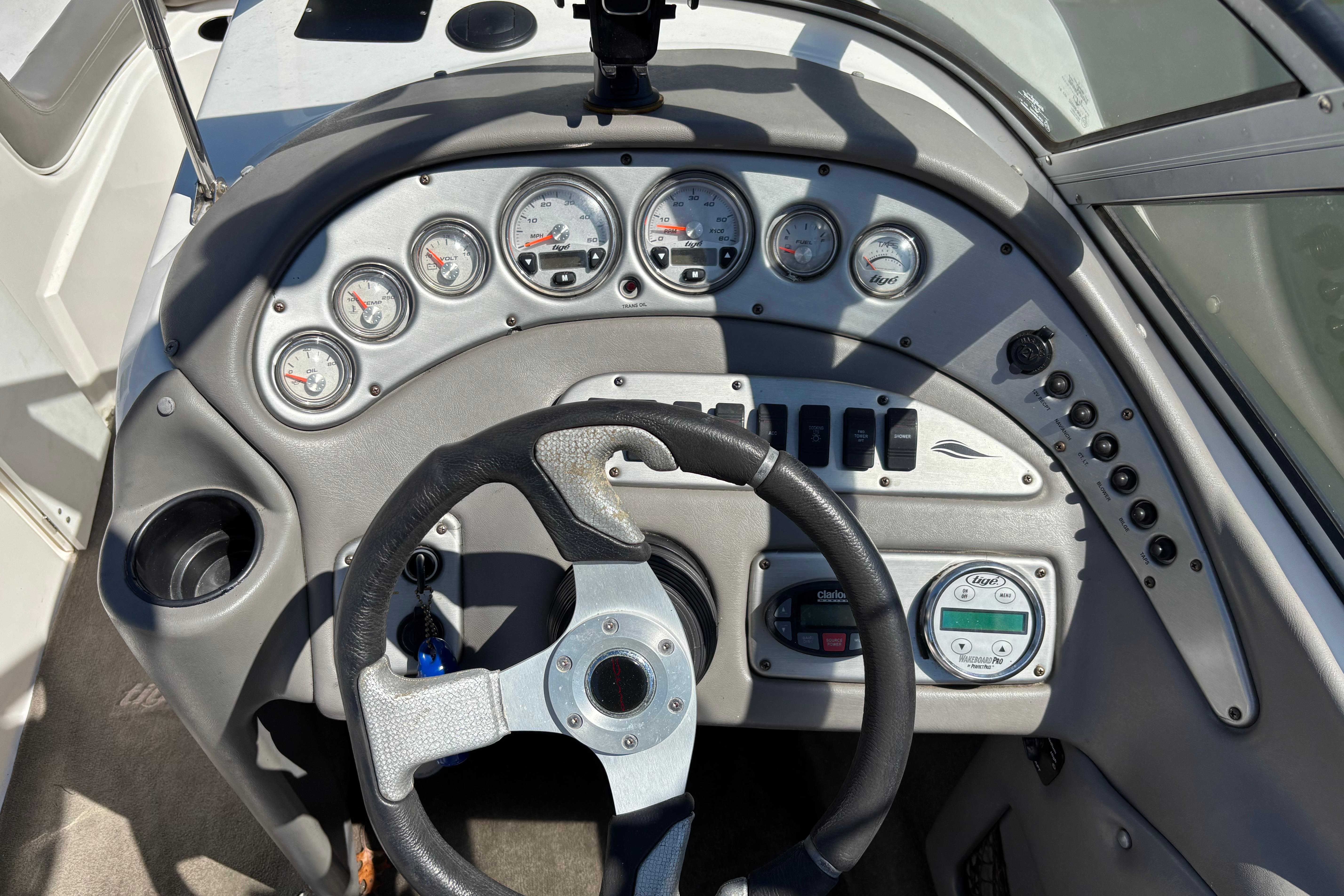 Dashboard of a 2004 Tigé 22V Limited Edition boat with gauges and steering wheel.