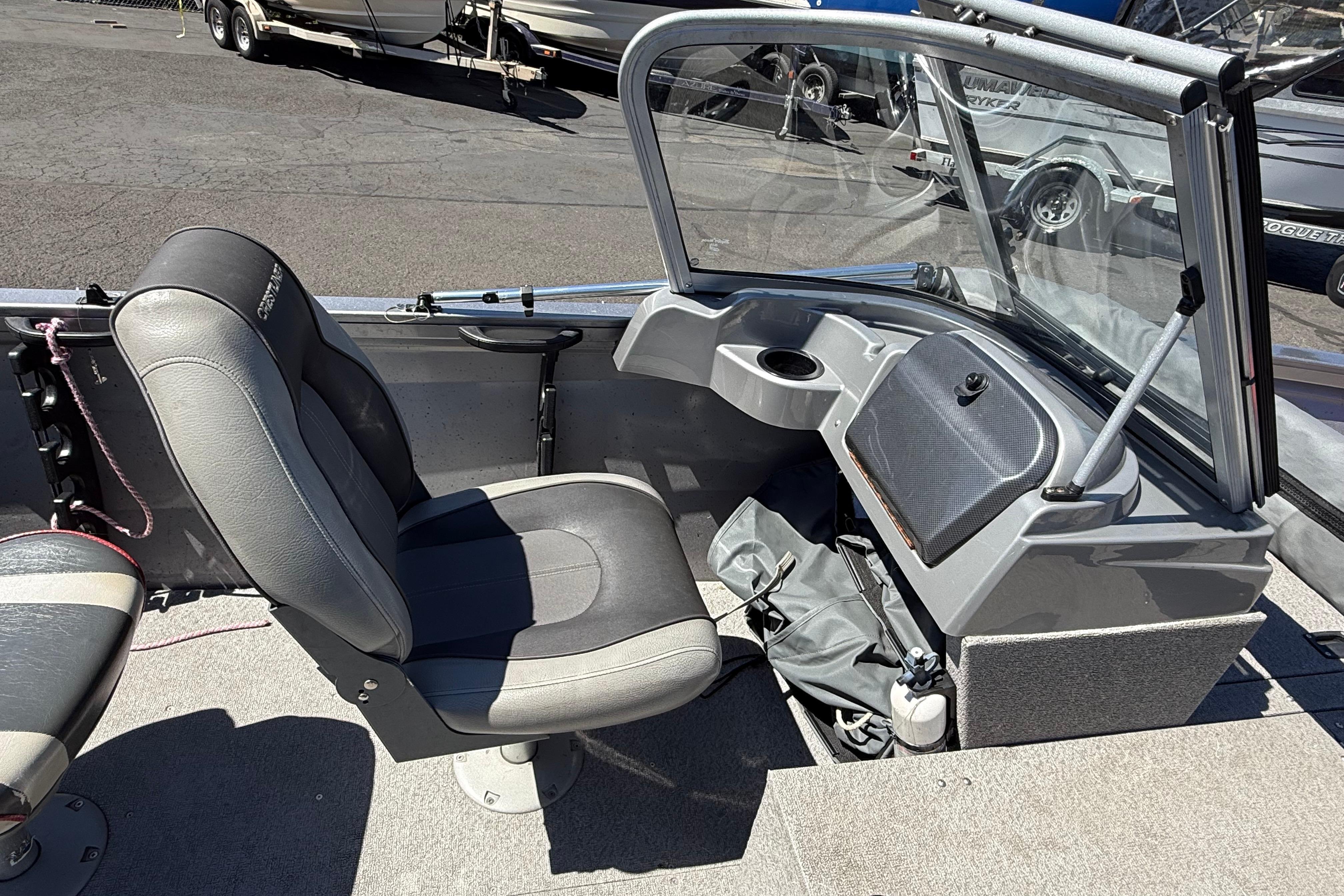 2016 Crestliner 1700 Vision boat interior with gray seating and dashboard.