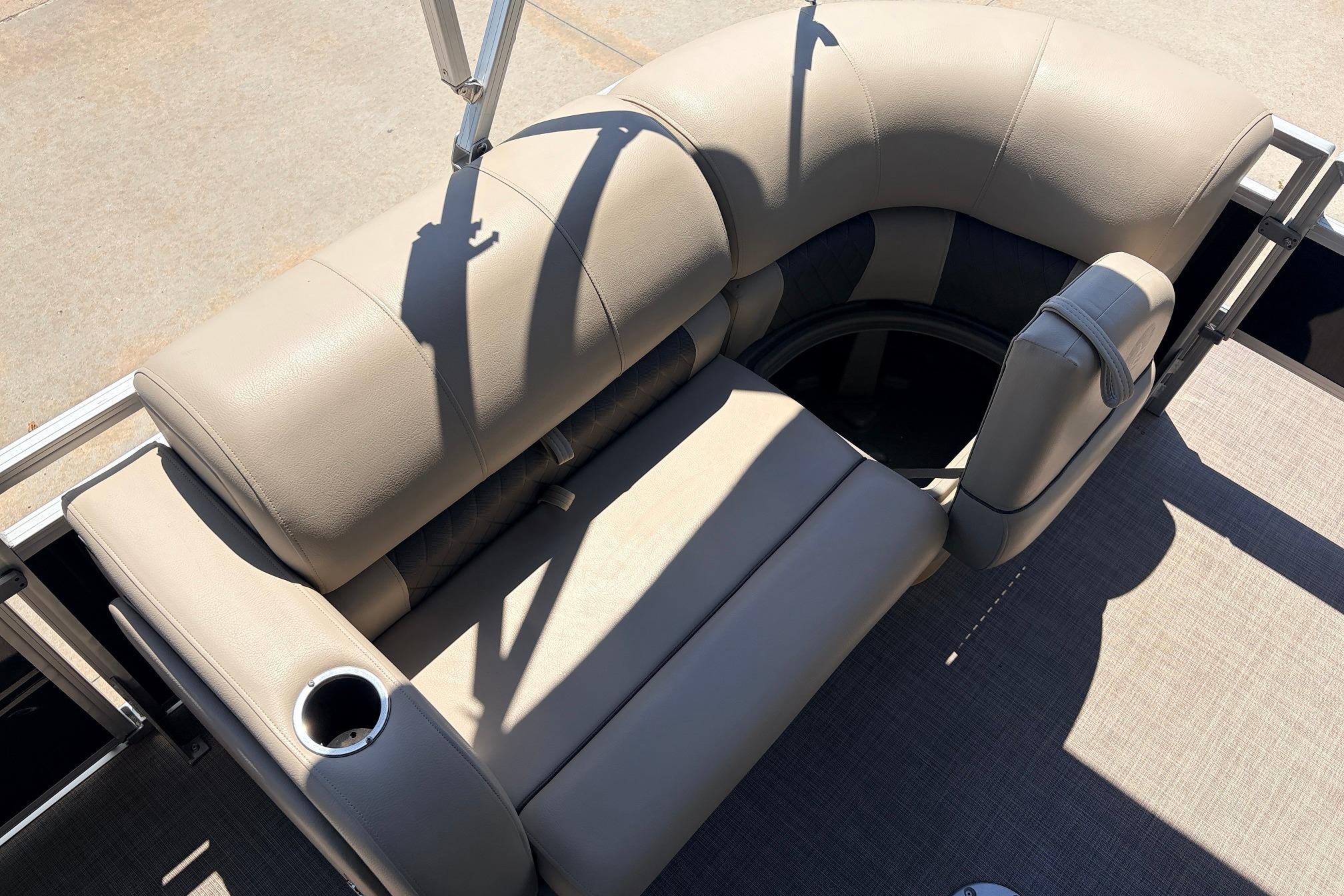 2024 Sun Tracker SportFish 22 XP3 boat seating with cup holder, beige upholstery.