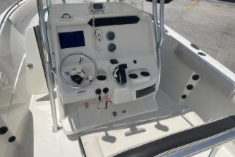2023 Sailfish 242 CC boat console with steering wheel and controls.