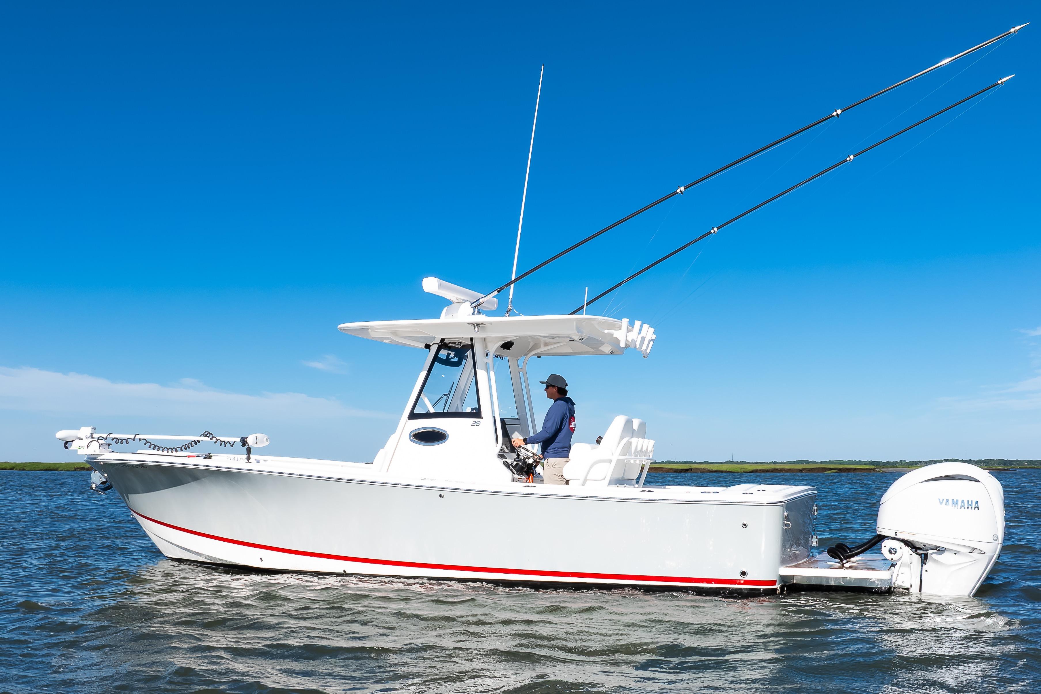 2022 Regulator 28 Forward Seating boat on water, clear blue sky background.