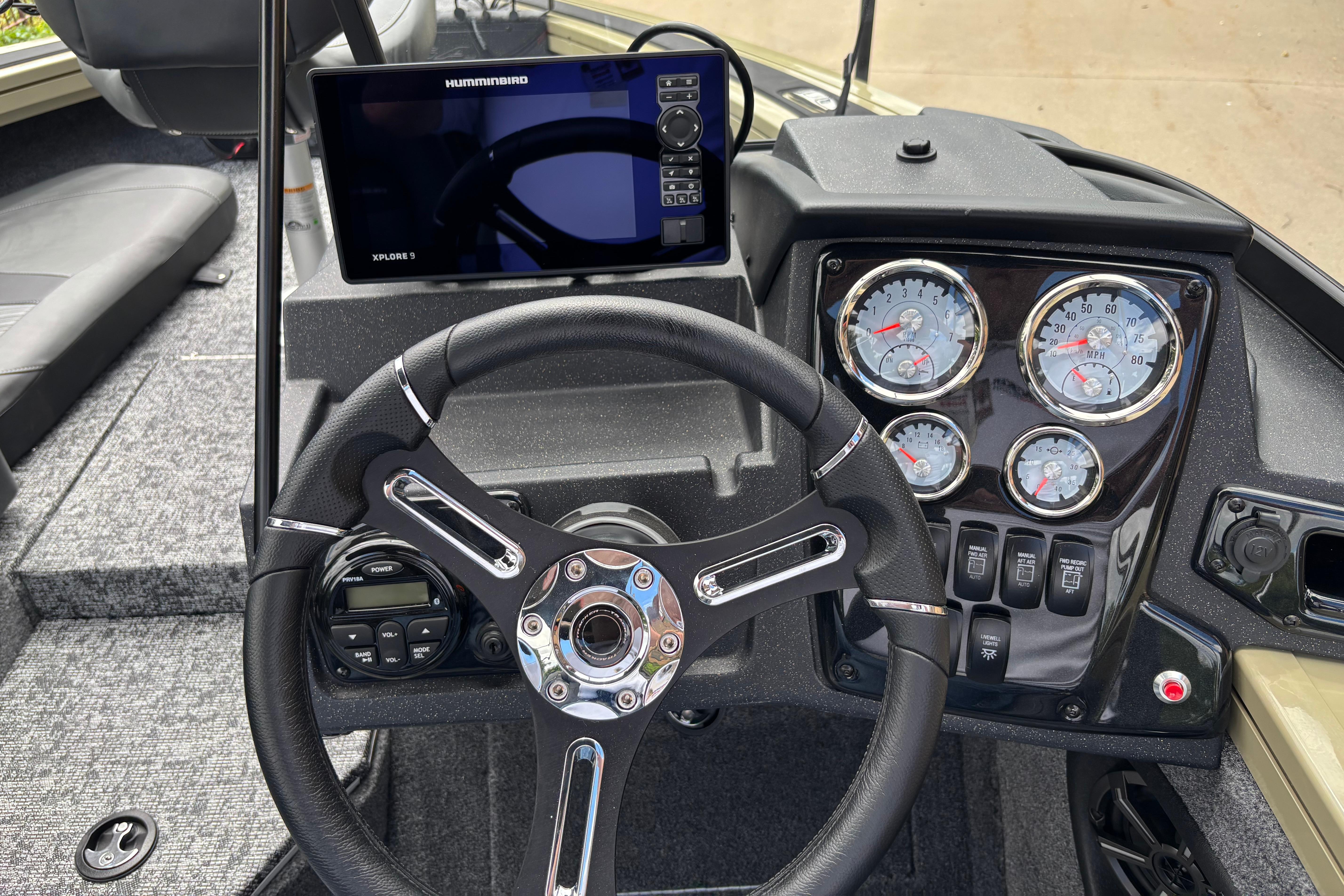 2026 Tracker Targa V-18 Combo dashboard with steering wheel, gauges, and Humminbird Xplore 9 display.