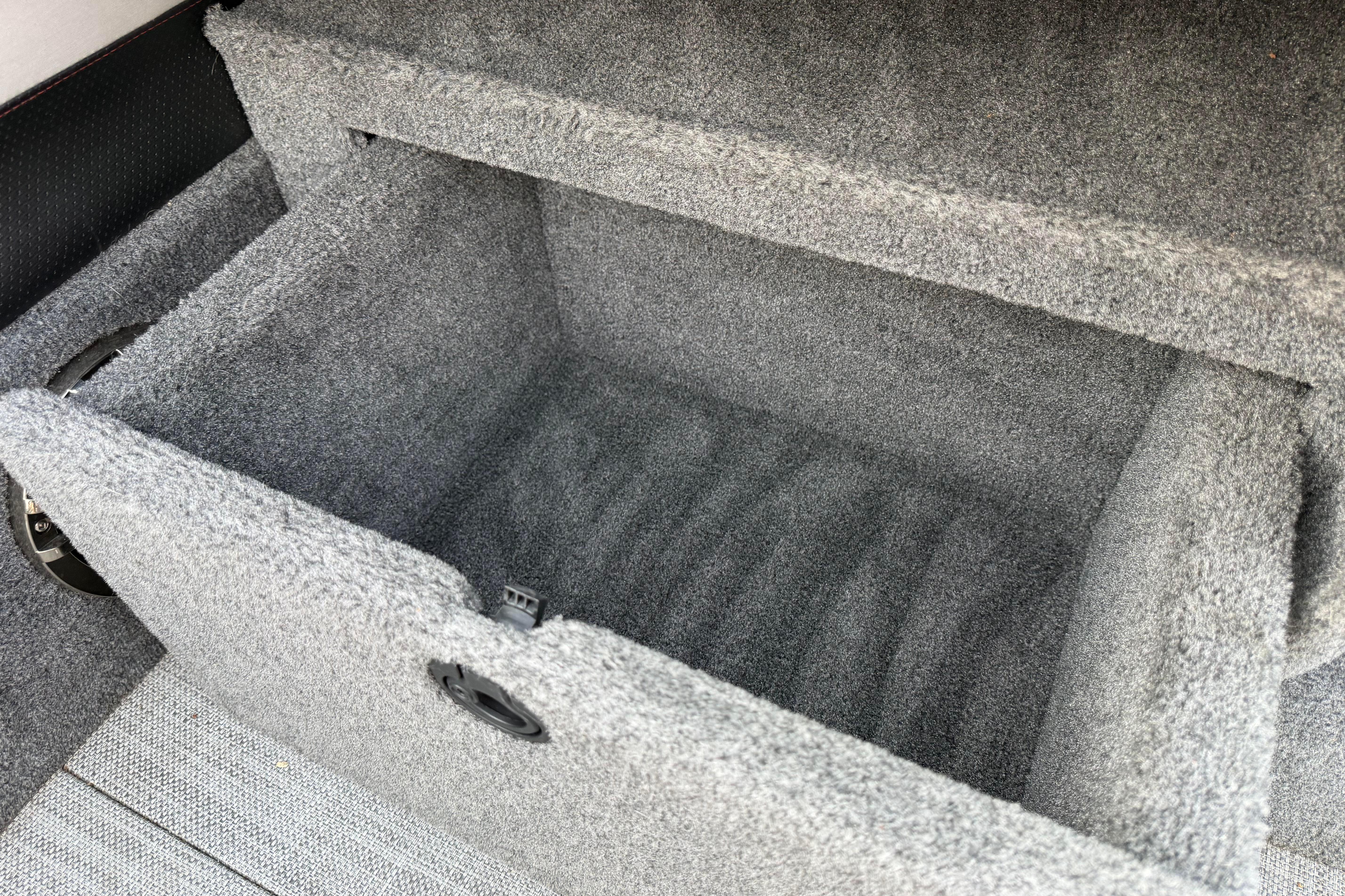 Carpeted storage compartment in a 2019 Alumacraft Trophy 205 boat.