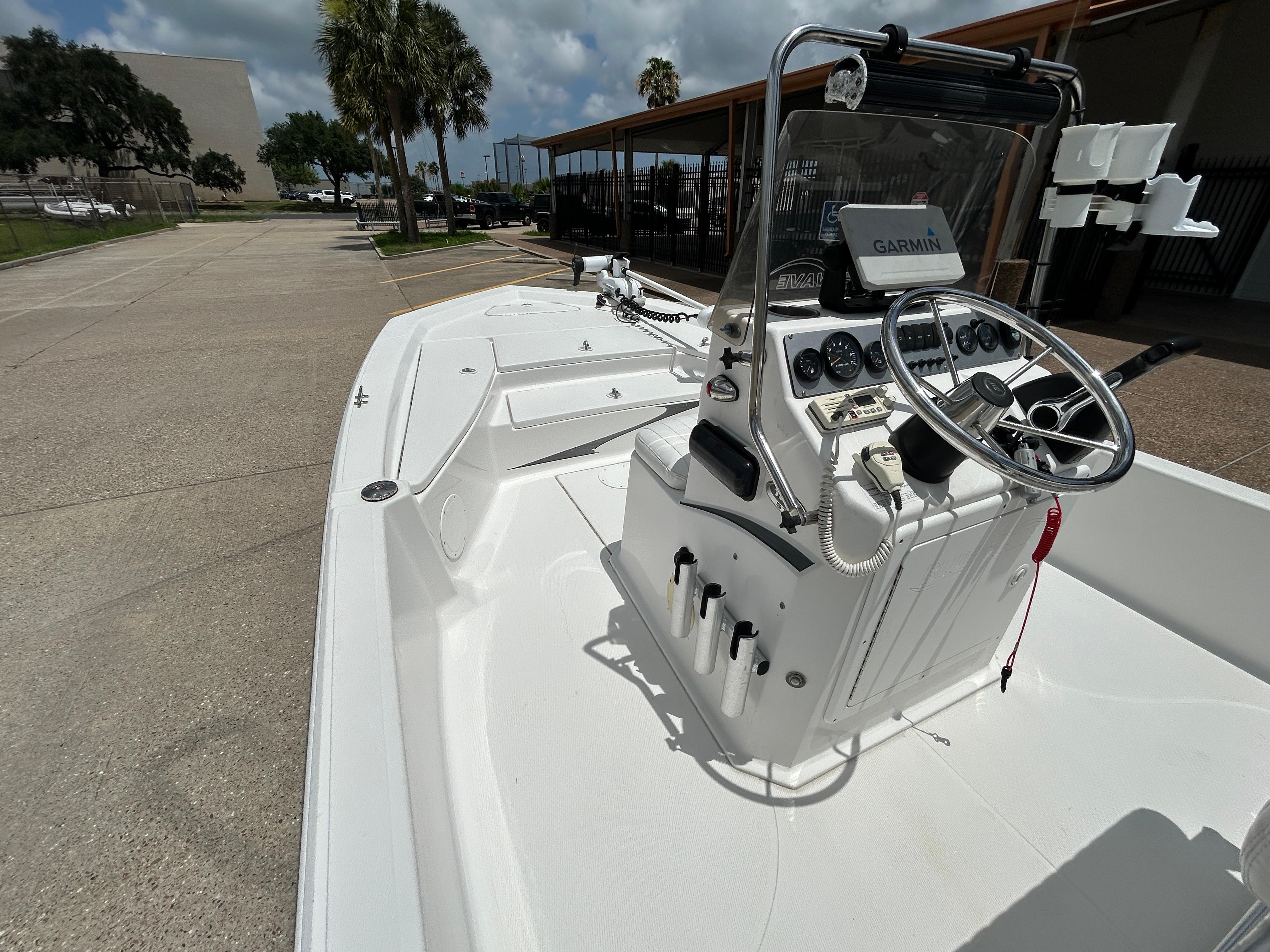 2012 Blue Wave 1900 STL boat with Garmin navigation, parked outdoors under a cloudy sky.