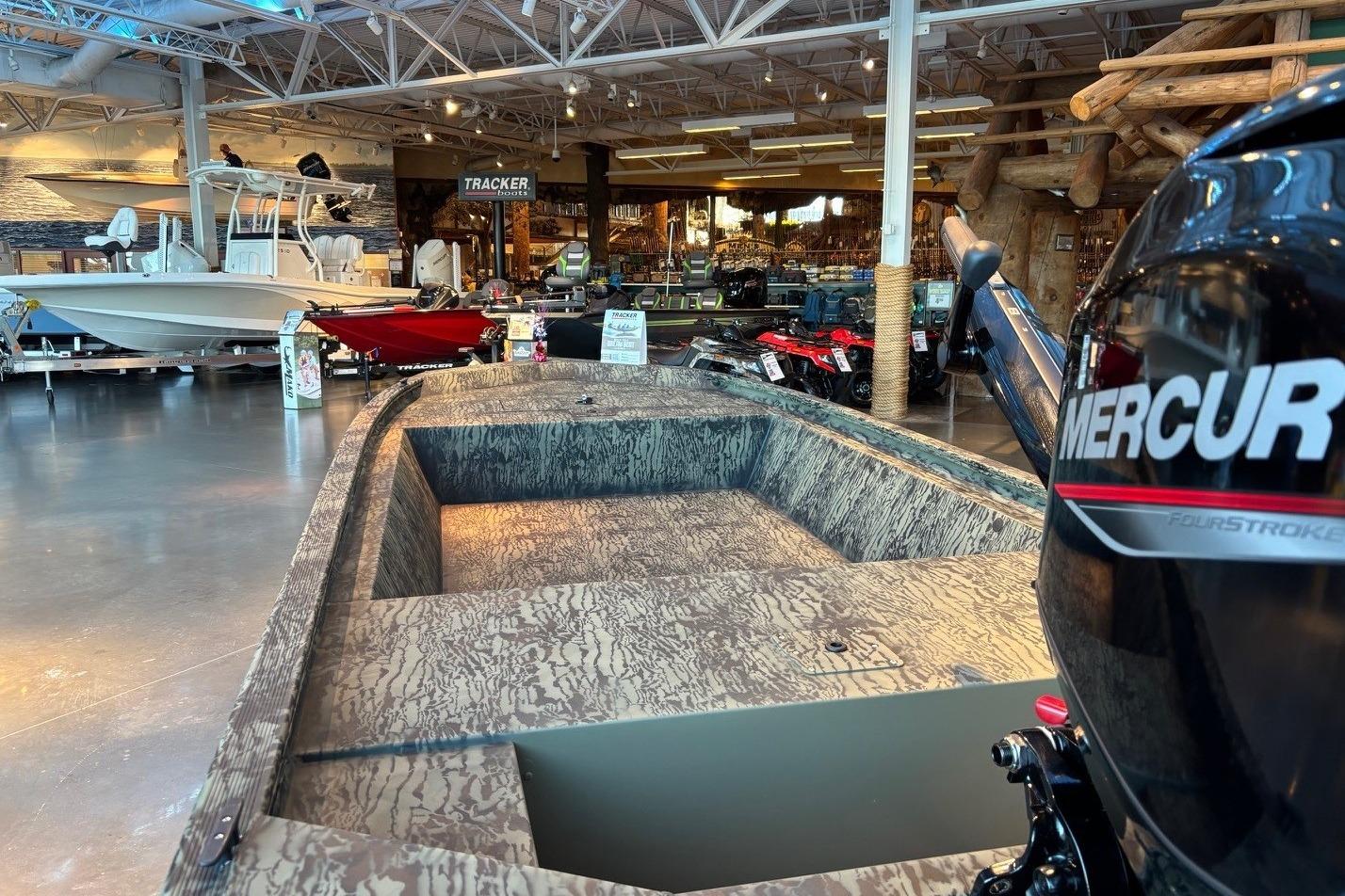 2026 Tracker Grizzly 1648 Utility boat with Mercury engine in showroom display.