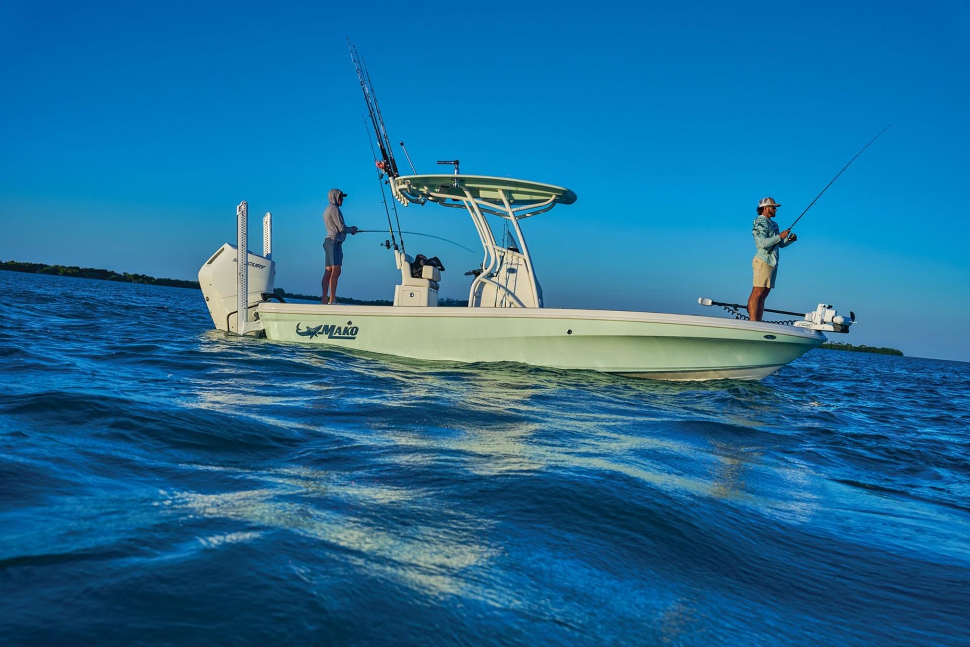 2026 Mako 24 APEX boat with two people fishing on a calm sea.