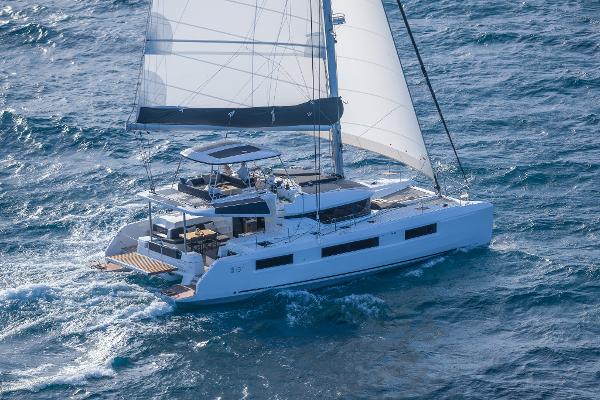 2025 Lagoon 51 ICONIC catamaran sailing on open sea with full sails.