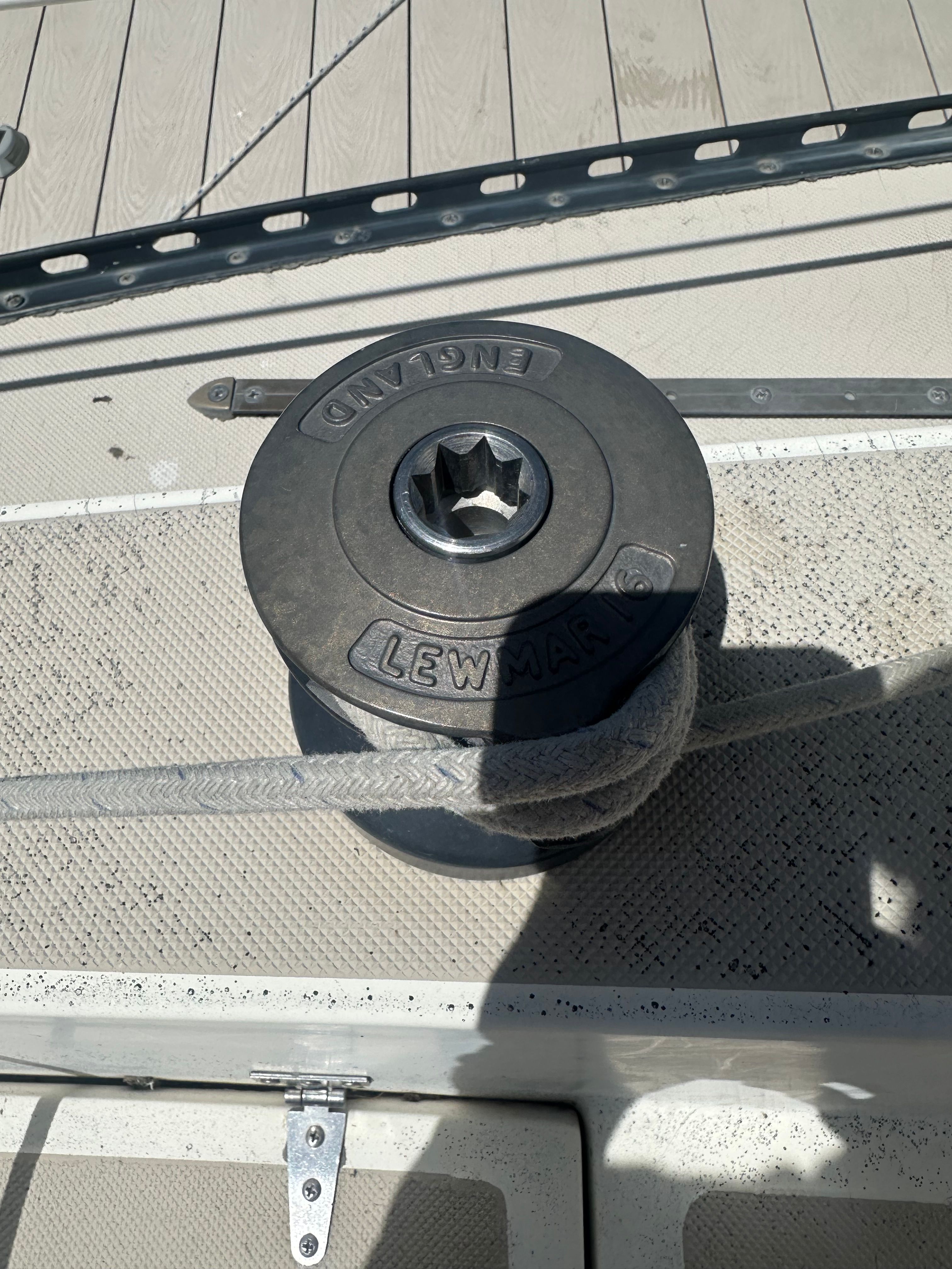 Close-up of a winch on a sailboat deck.