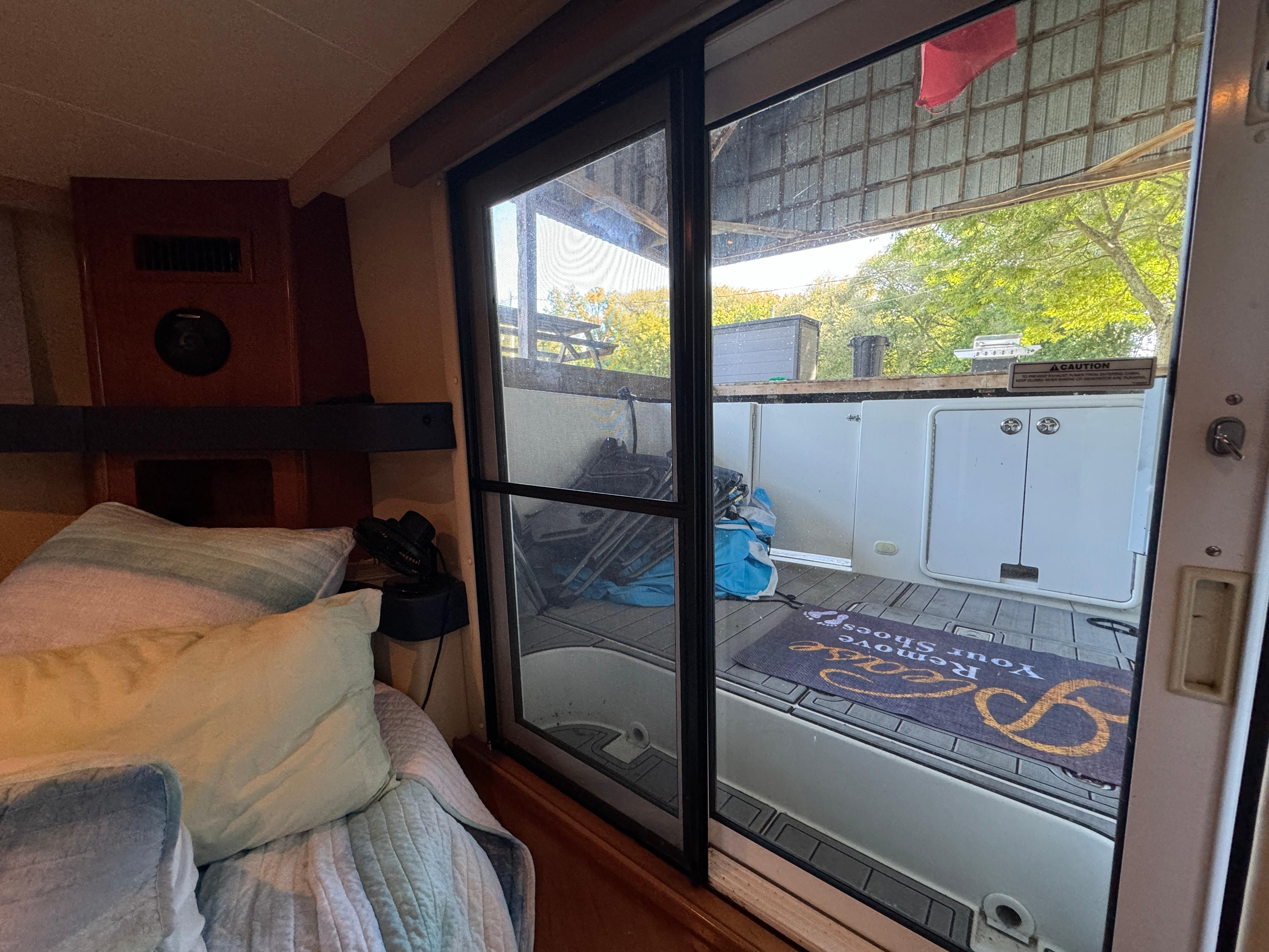 Interior view of 2005 Carver 41 Cockpit Motor Yacht, showing cozy cabin and deck access.