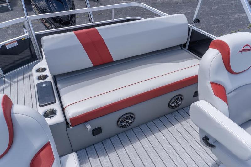 2026 SunCatcher Select 322SL boat interior with gray and red seating, cup holders, and speakers.