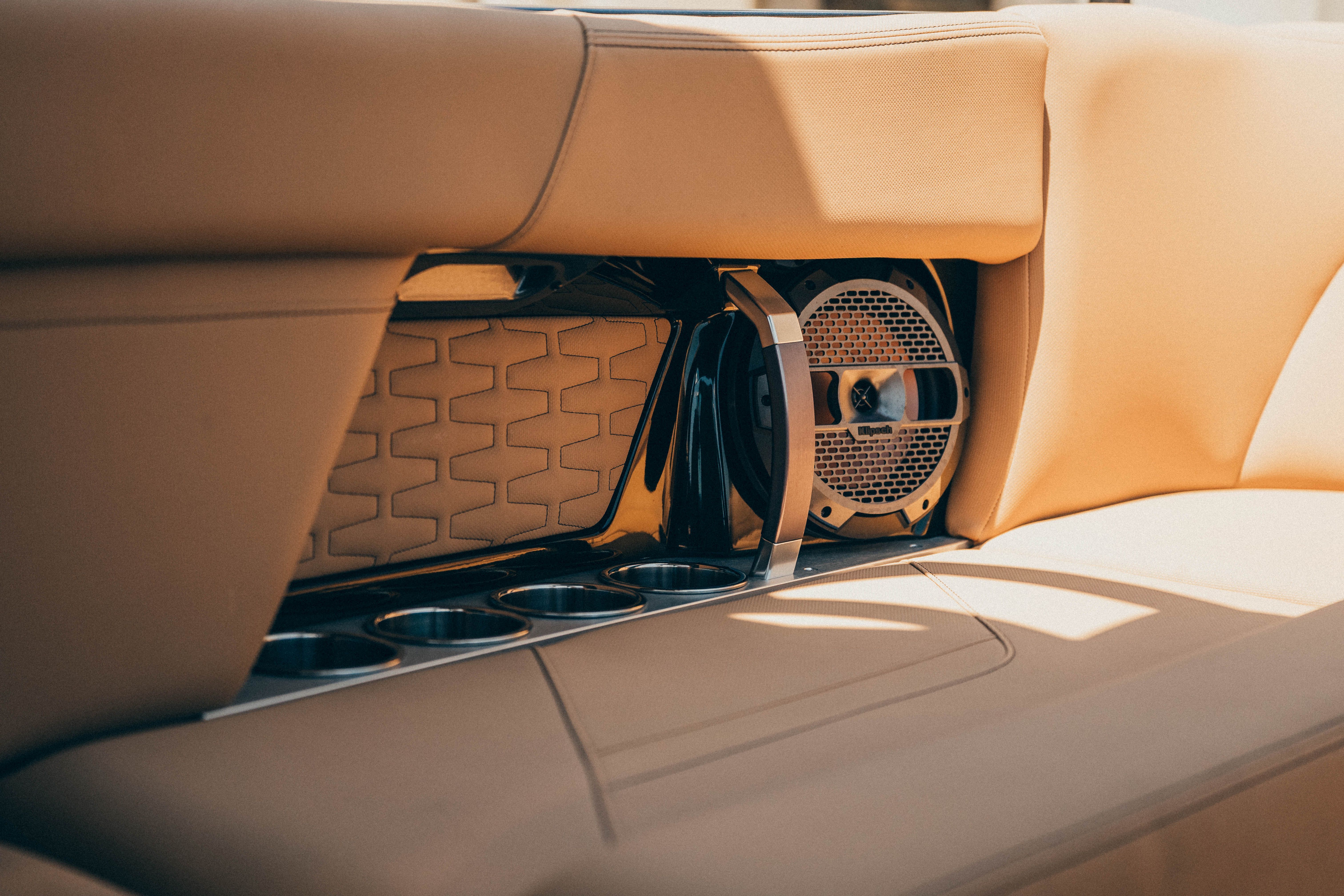 Close-up of a speaker and cup holders on a MasterCraft X26 boat.