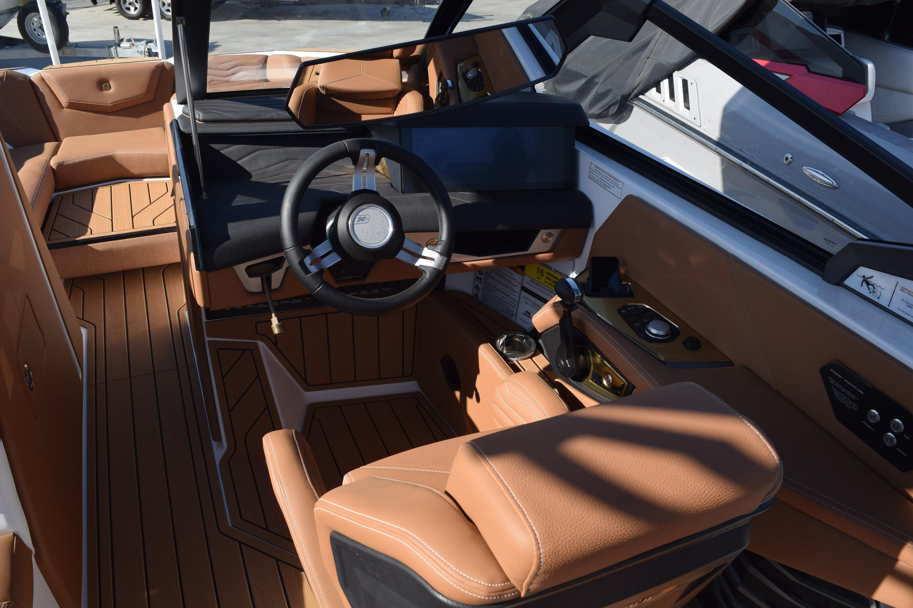 2026 Nautique Super Air Nautique G23 interior with luxurious tan leather seating and modern dashboard.