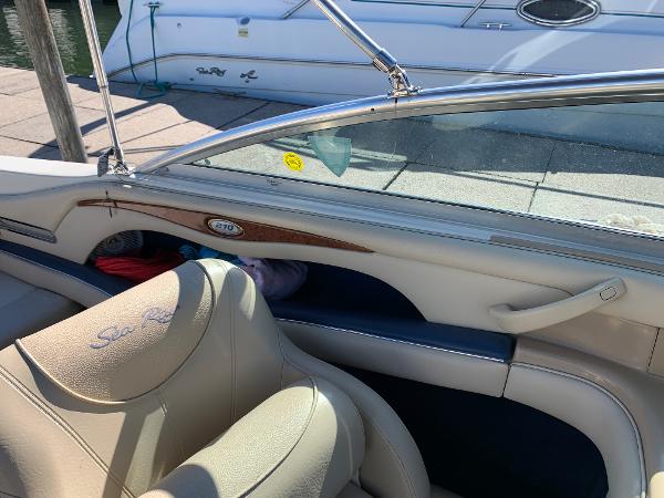 Interior of a 2000 Sea Ray 210 Bow Rider boat with beige seating.