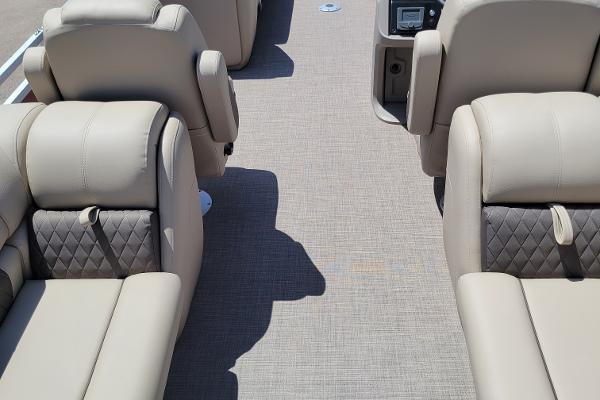 2024 Sun Tracker Party Barge 24 DLX interior with beige seating and carpeted floor.