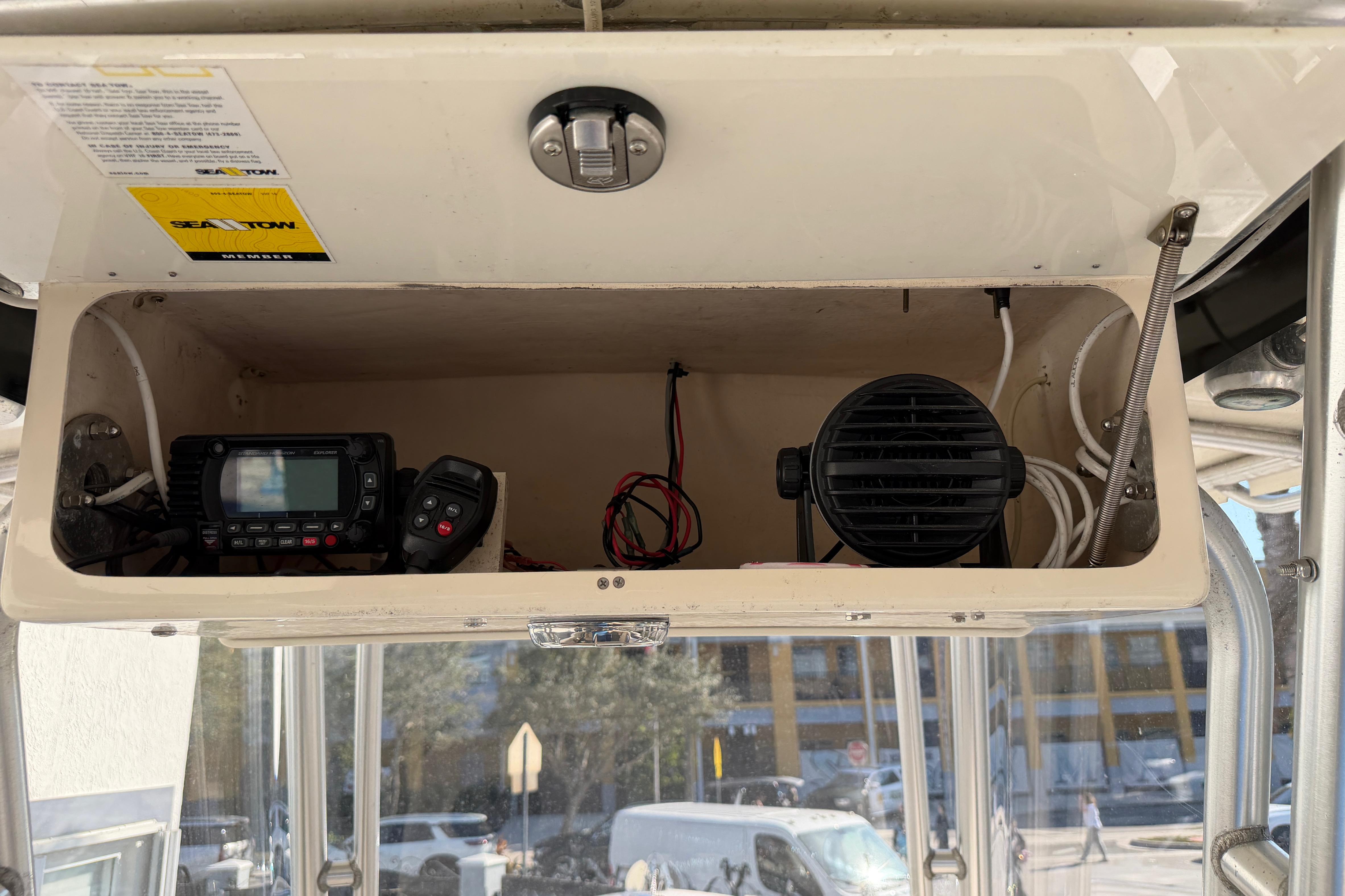 2004 Grady White 273 boat electronics compartment with radio and speaker.